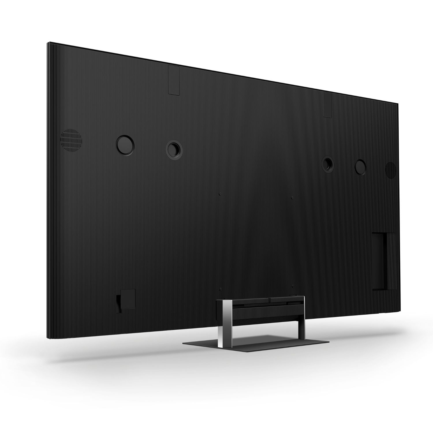 Vista trasera de un televisor de pantalla plana negro con textura acanalada y soporte plateado.