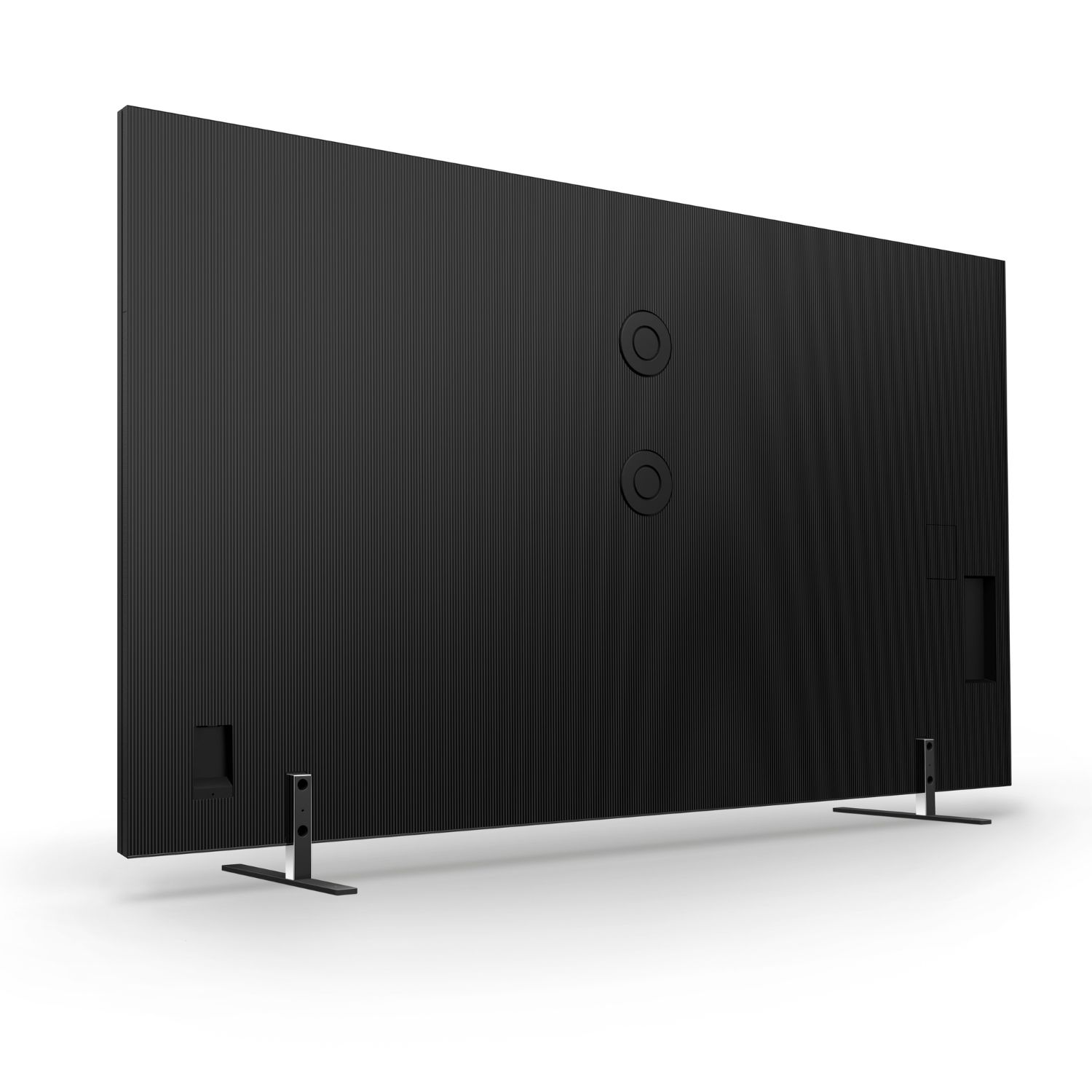 Parte trasera de un televisor negro con textura acanalada y dos puertos redondos.
