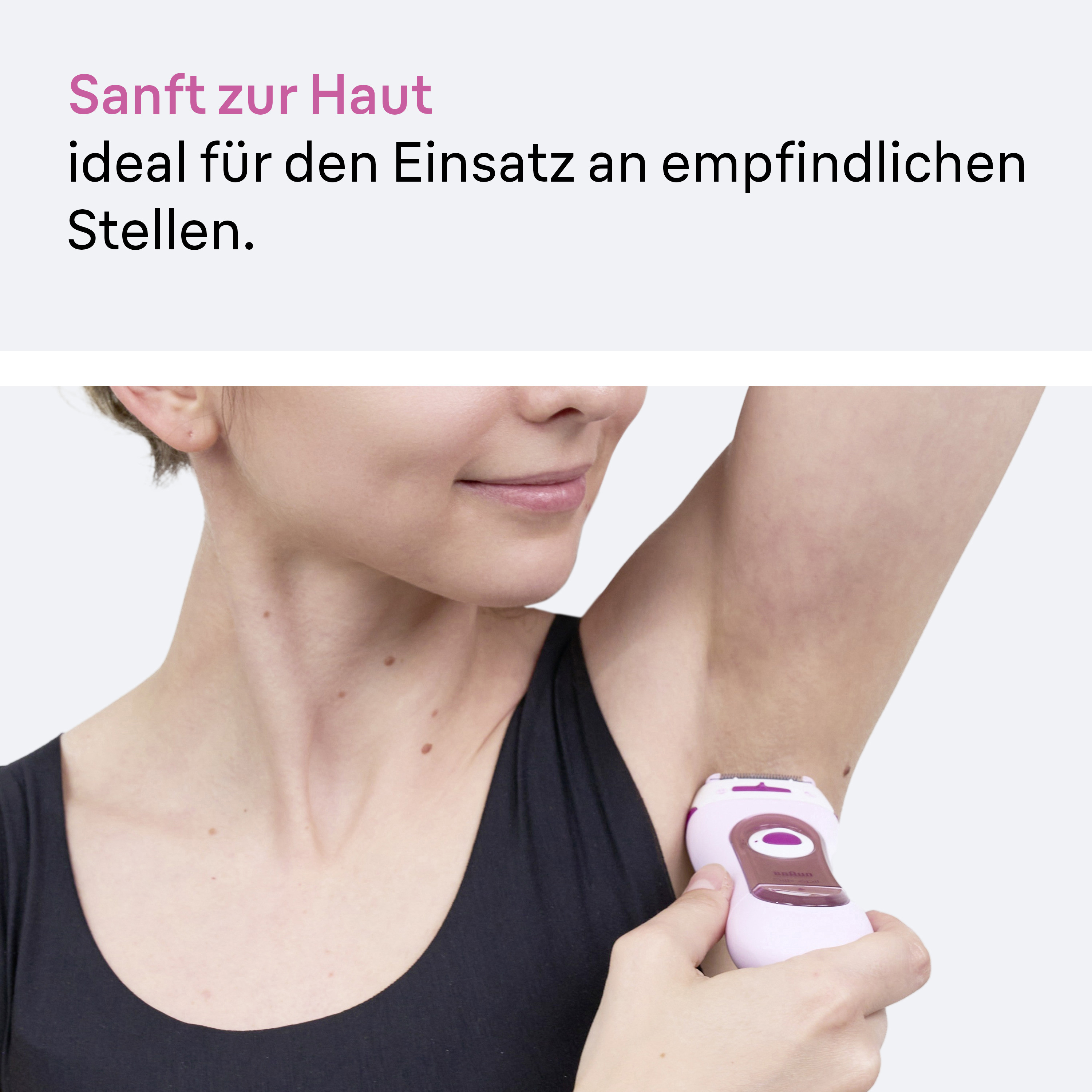 Eine Frau rasiert ihre Achselhöhle mit einem rosa Epilierer.