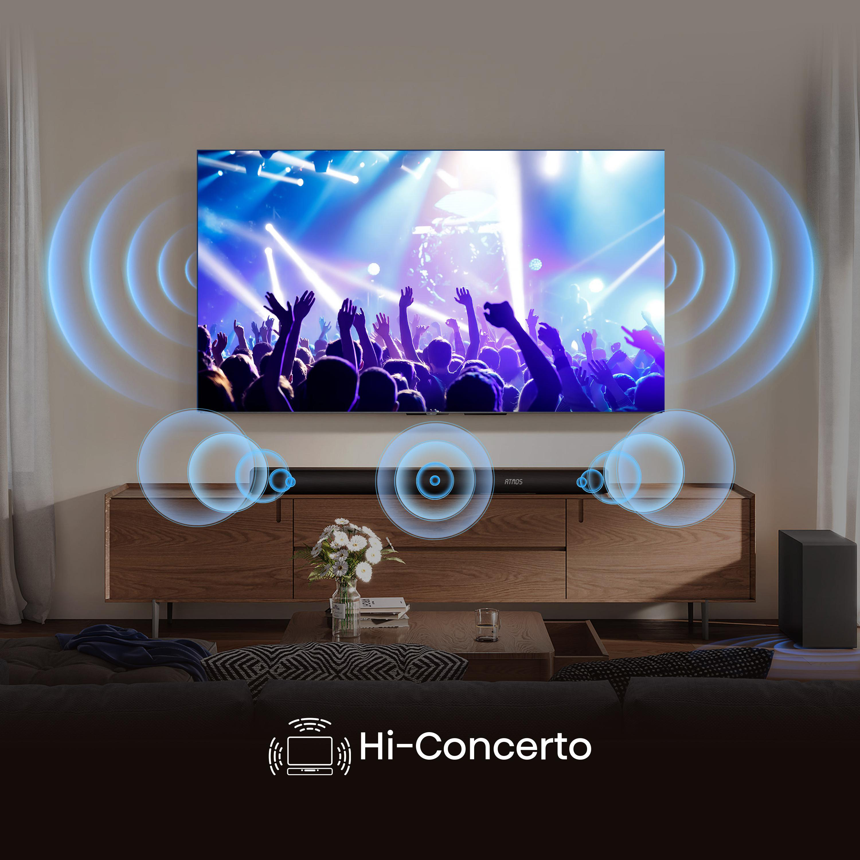 Ein Fernseher zeigt ein Konzert mit blauem Licht. Ein Soundbar ist darunter.