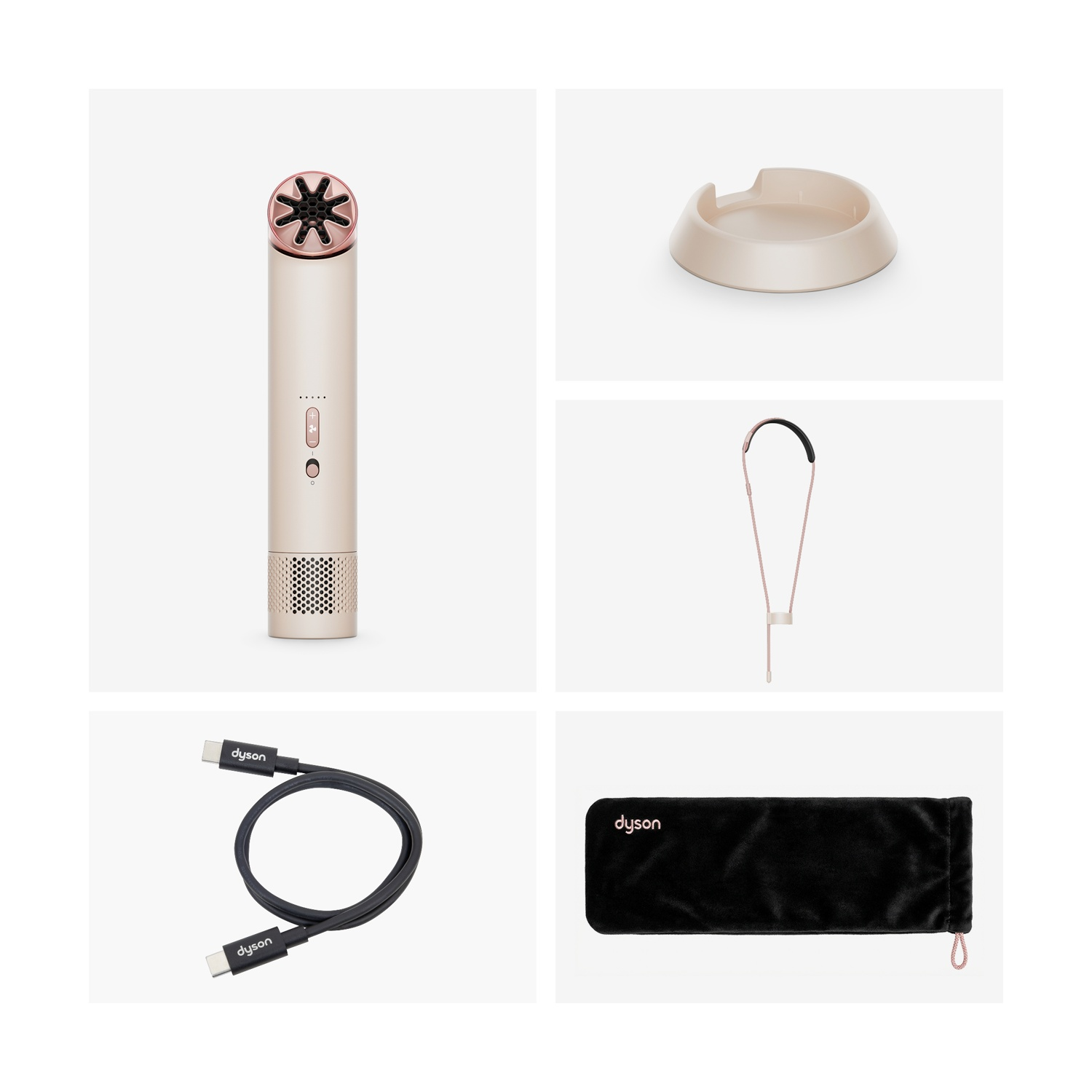 Una piastra per capelli Dyson dorata con accessorio a stella, base di ricarica, cinturino, cavo e custodia.