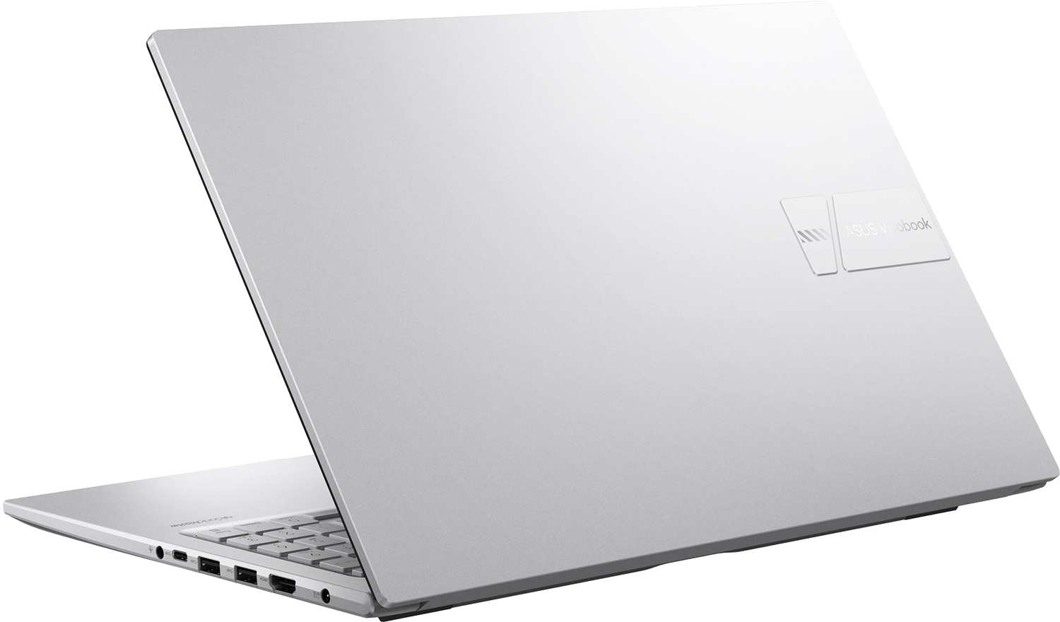 Egy ezüst Asus Vivobook laptop nyitott fedéllel, megvilágított billentyűzettel.