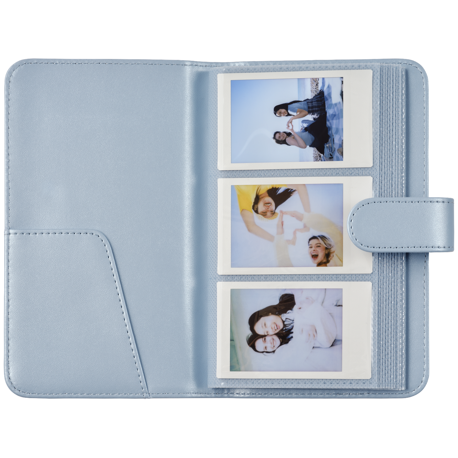 A light blue photo album holding three instant photos of young women.