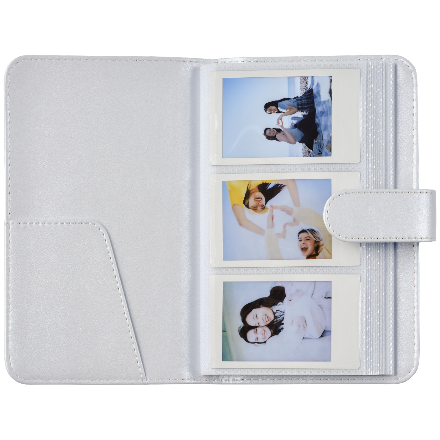 A white photo album holding three instant photos of young women.