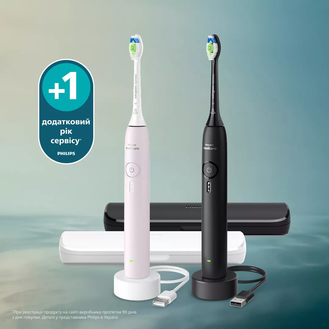 Zwei Philips Sonicare Zahnbürsten, eine weiße und eine schwarze, mit Ladezubehör.