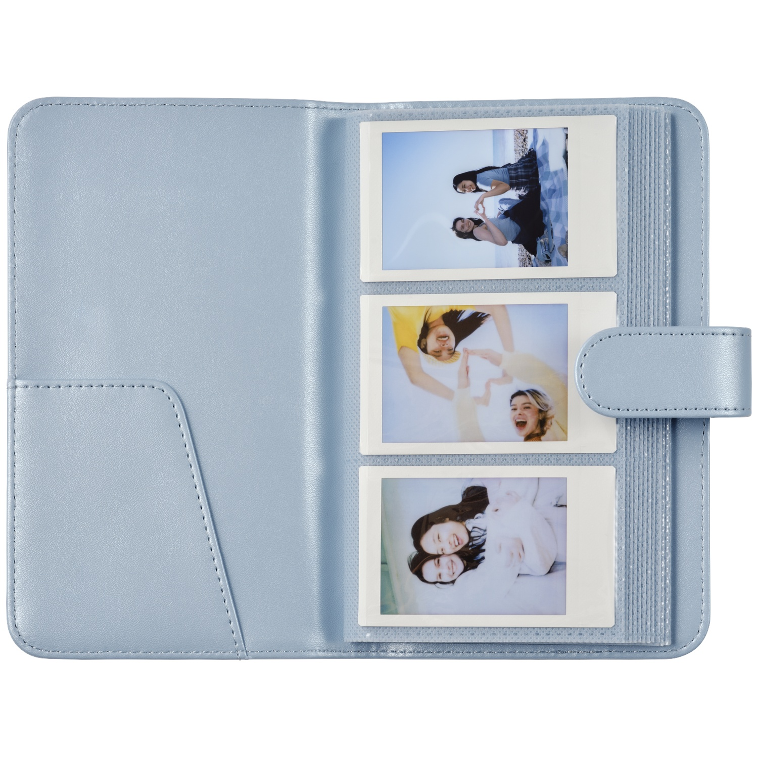 Light blue photo album with three instant photos of smiling young women.