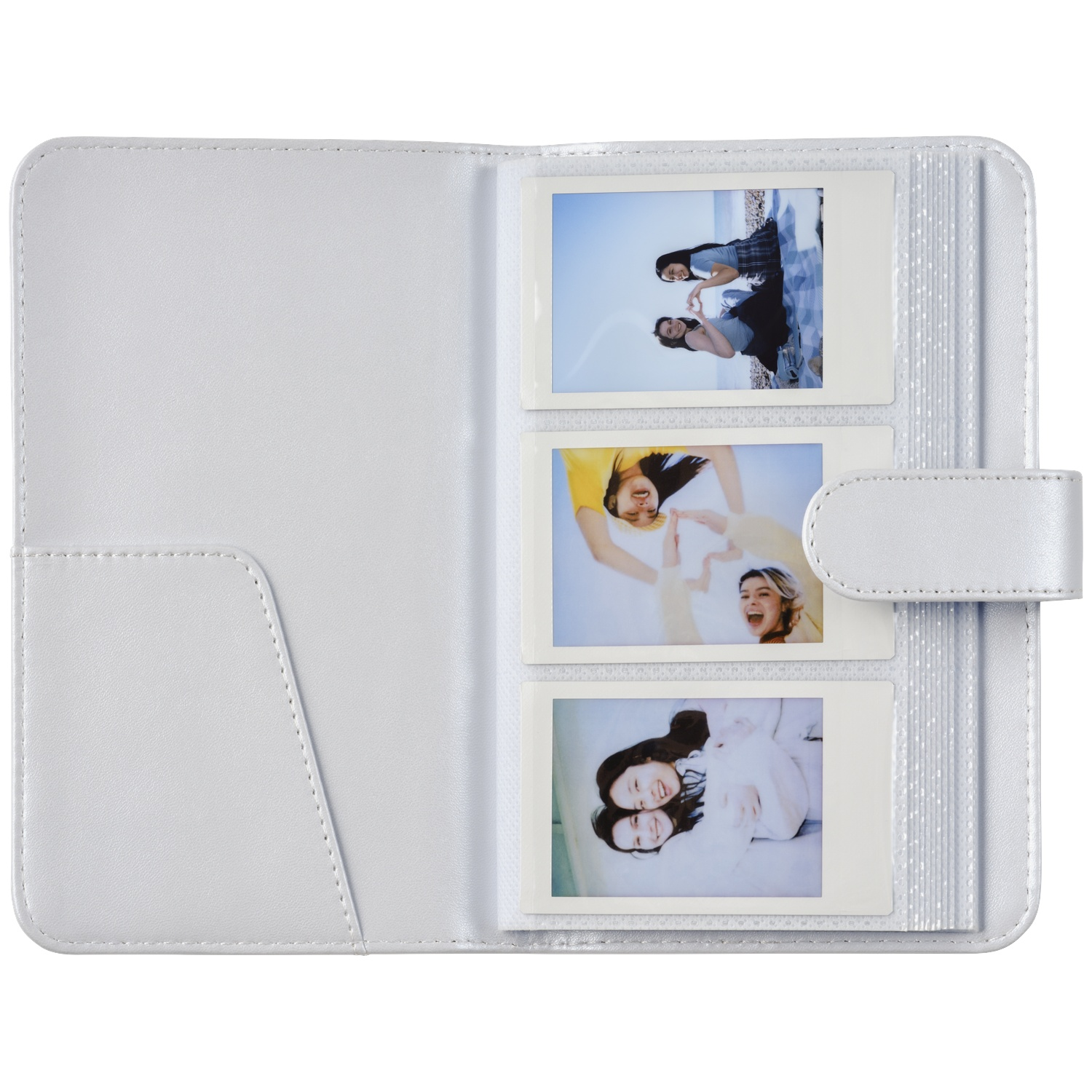 A white photo album with three upright instant photos of women.