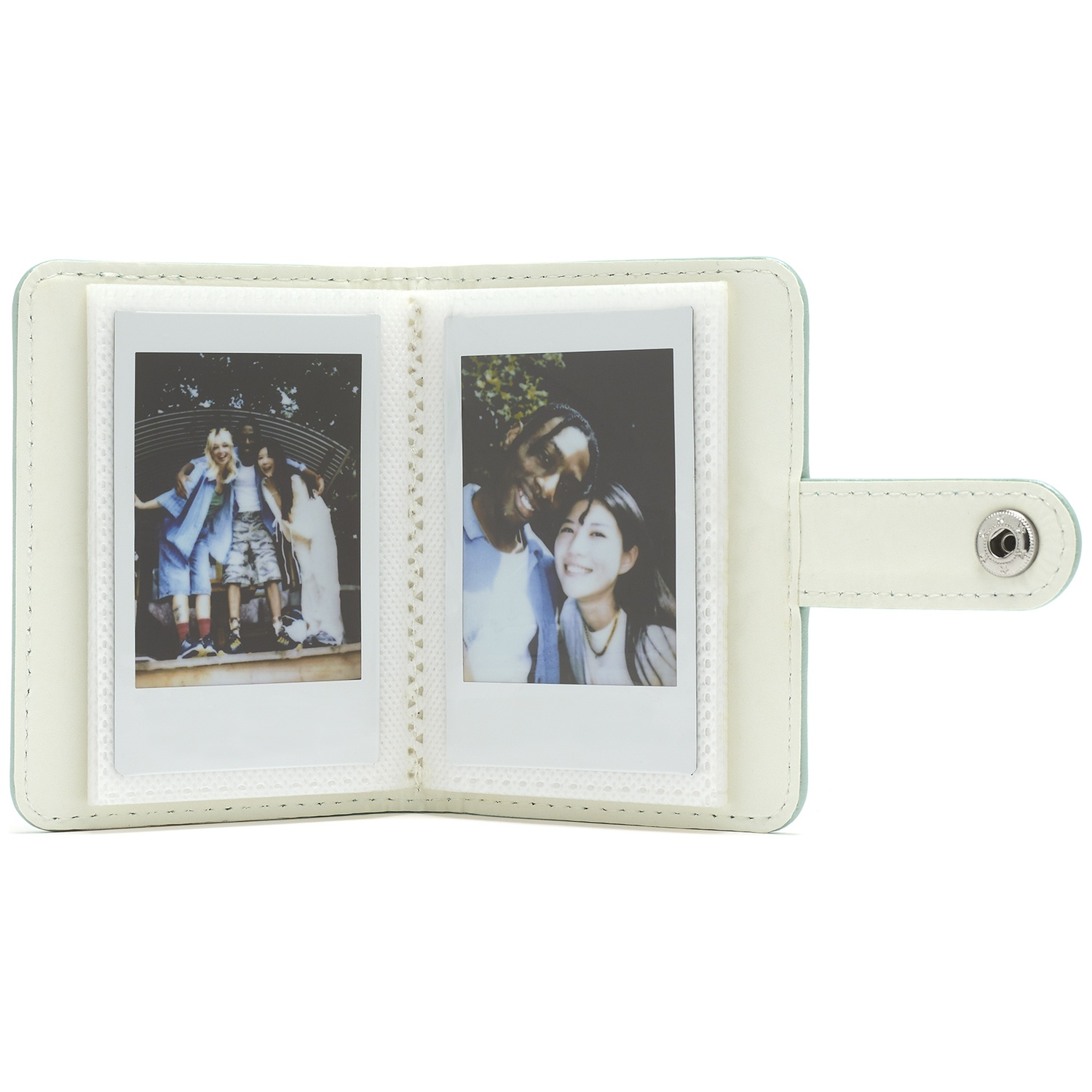 A light green photo album holding two instant photos of people.