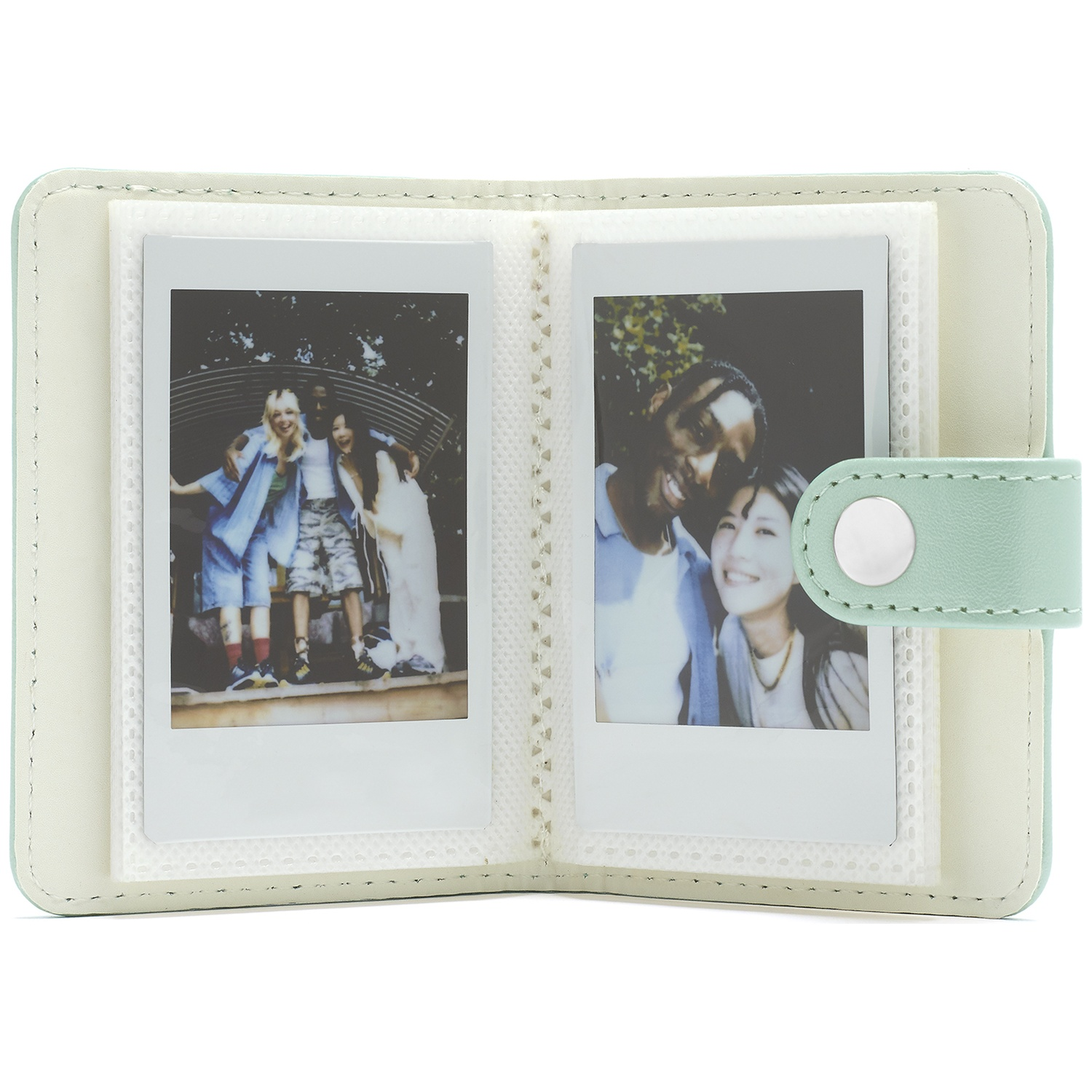A light green photo album holding two instant photos of friends.
