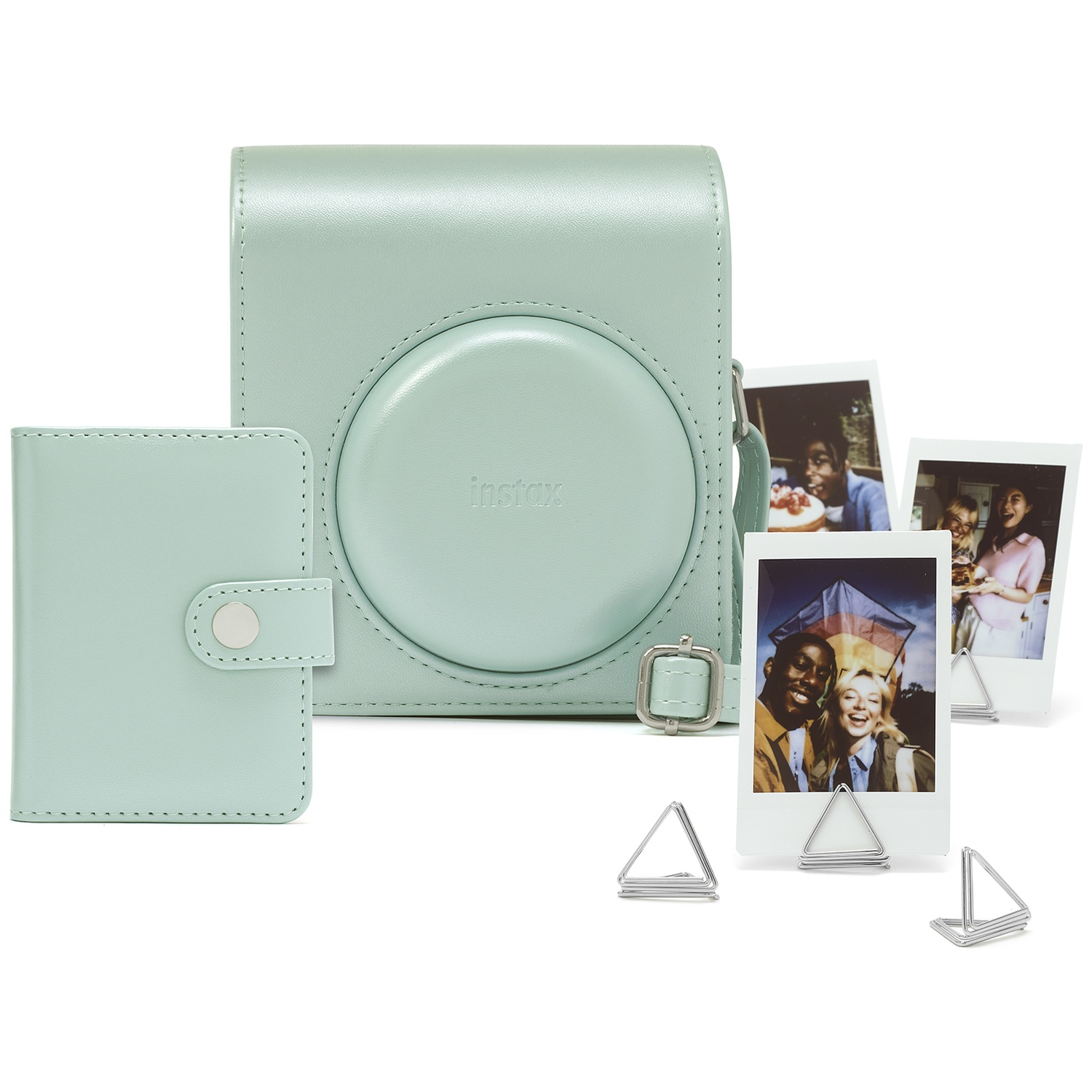A mint green Instax camera case and photo album with framed photos.