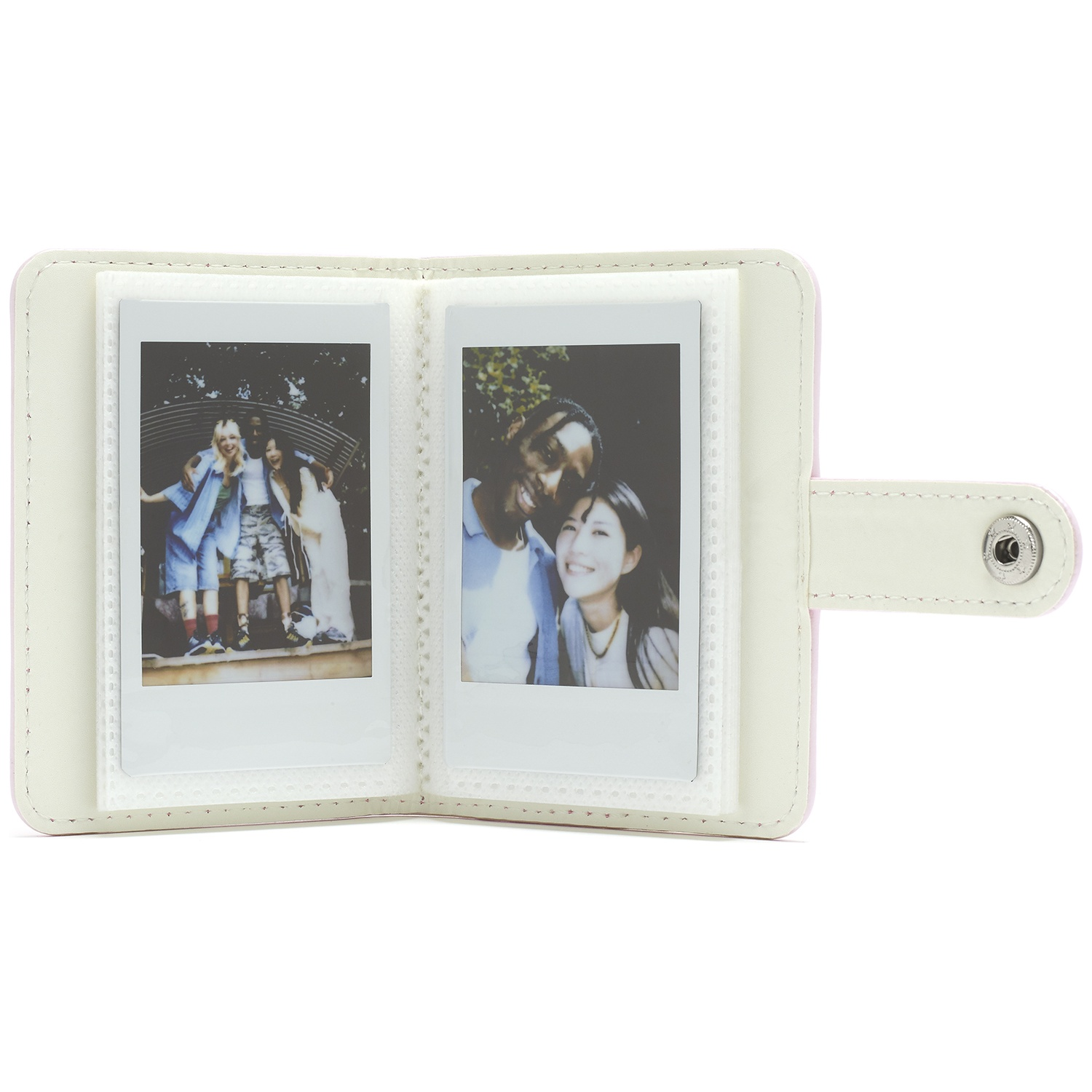A white photo album open to show two polaroid pictures of people.