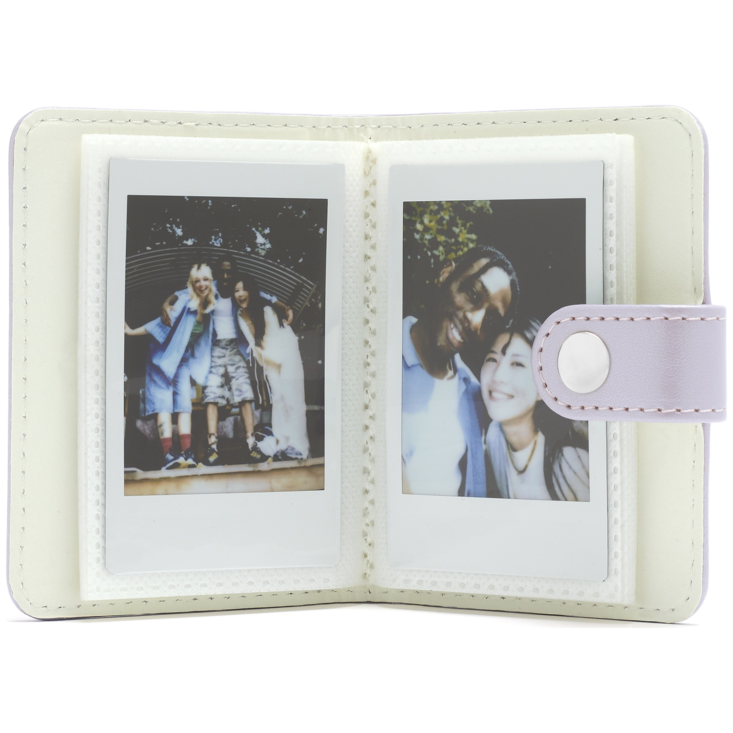An open album holding two instant photos of smiling friends.