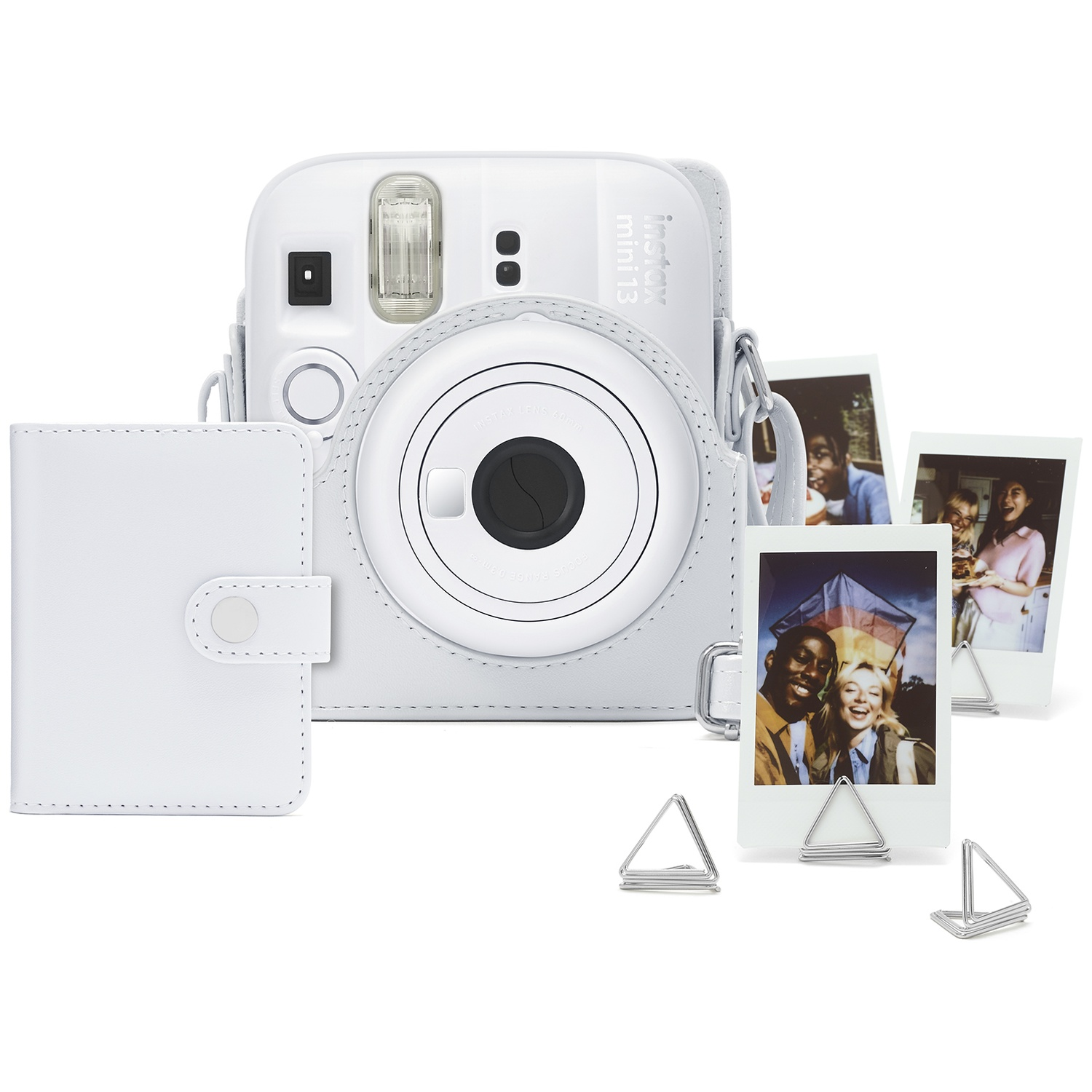 White instant camera with case and photos. Close-up view.