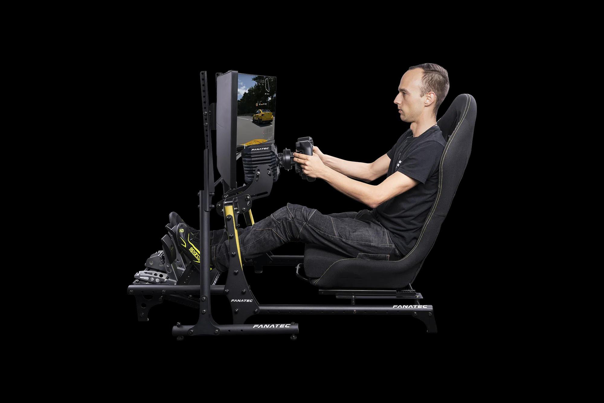 Ein Mann spielt ein Rennspiel auf einem Simulator mit Lenkrad und Pedalen.