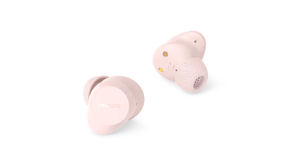 Dwa jasnoróżowe słuchawki Philips są pokazane na czarnym tle. Lewa słuchawka ma logo Philips.