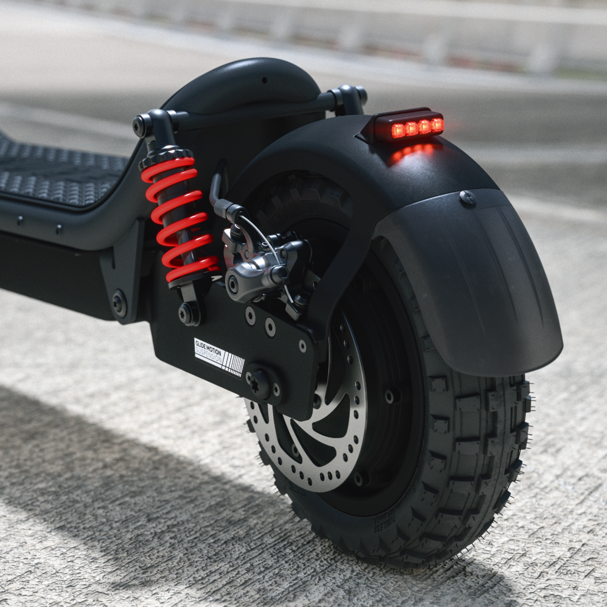Schwarzer E-Scooter Hinterrad mit roter Stoßdämpfer und Bremsscheibe.