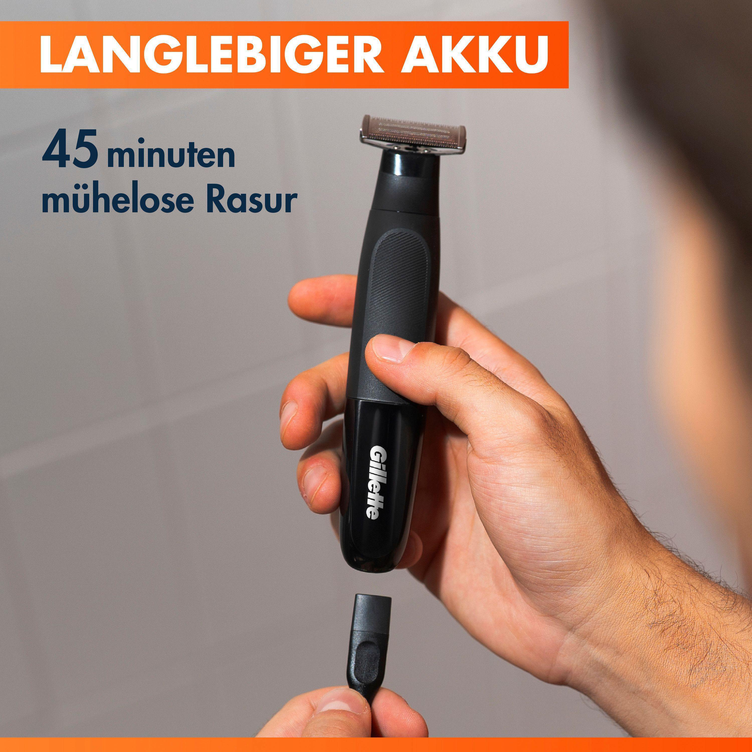 Mann hält einen schwarzen Gillette Rasierer mit abnehmbarem Aufsatz. Langlebiger Akku.