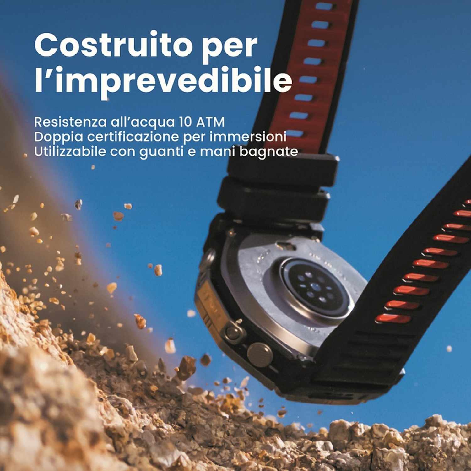 Un robusto orologio con cinturino nero e rosso cade su rocce, cielo blu