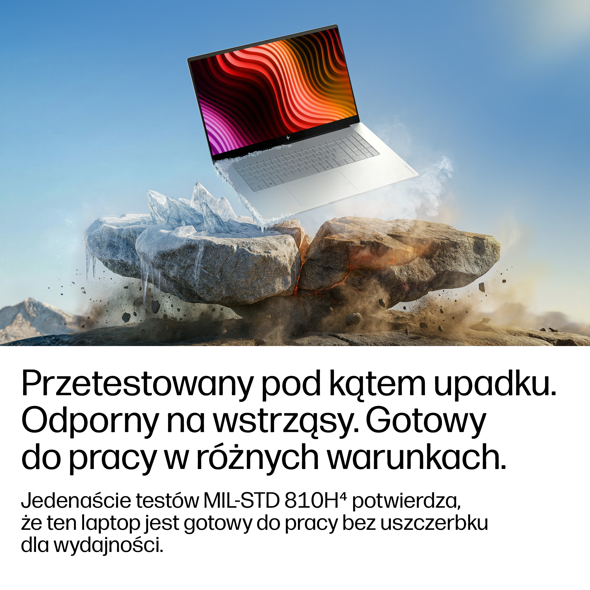 Laptop unosi się nad nierównym terenem z lodem i skałami.