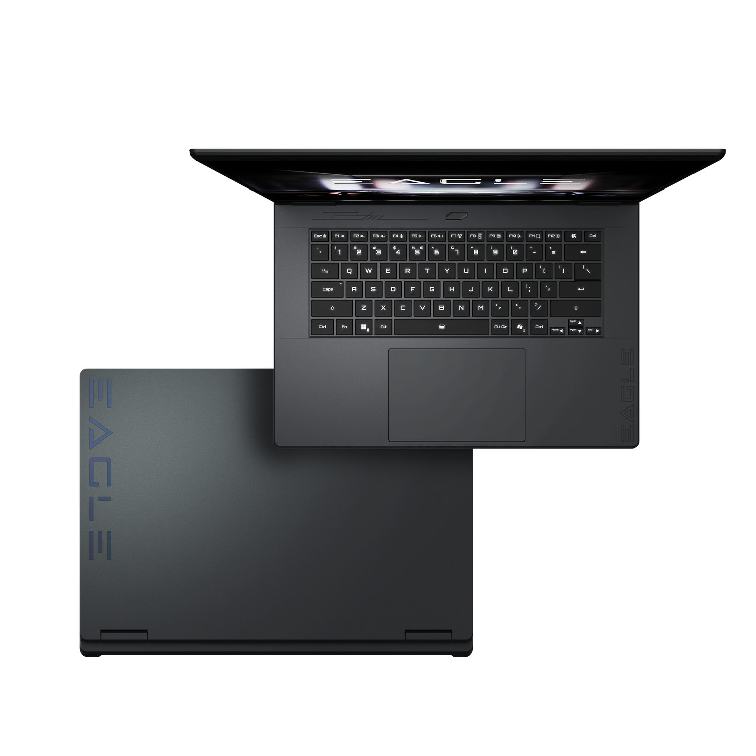 Un portátil oscuro abierto muestra su teclado. Otro portátil oscuro cerrado está a su lado.