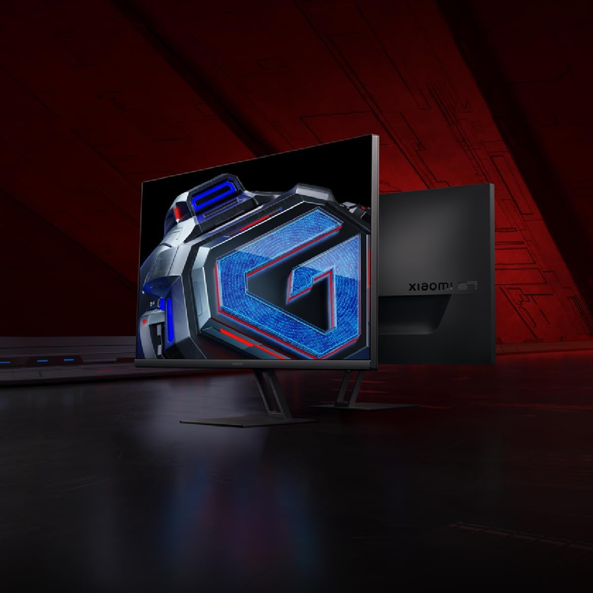 Un monitor gaming con un logo 'G' azul estilizado y detalles rojos.