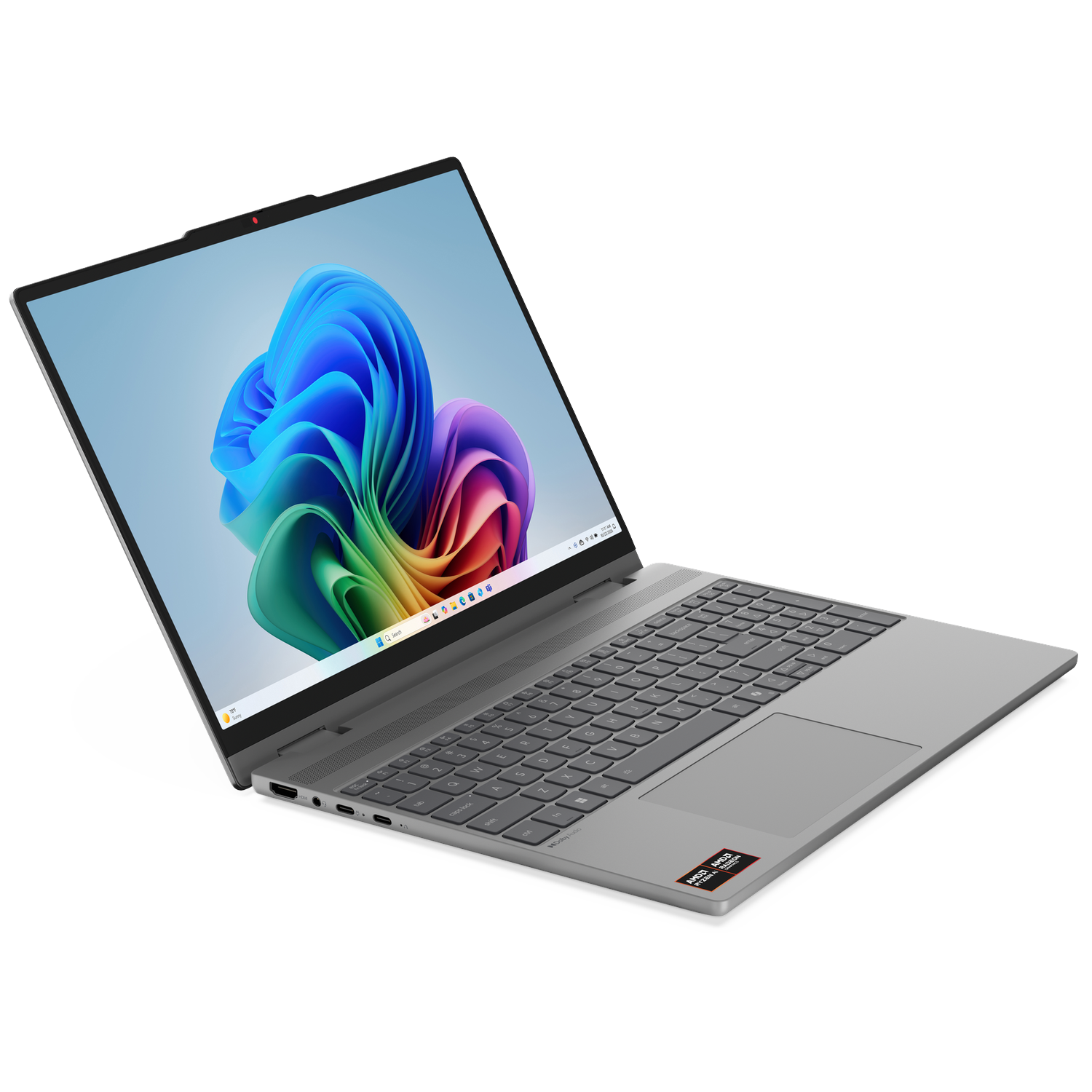 A silver laptop is angled on a black background, displaying a colorful, abstract wallpaper with blue, green, and red hues.
