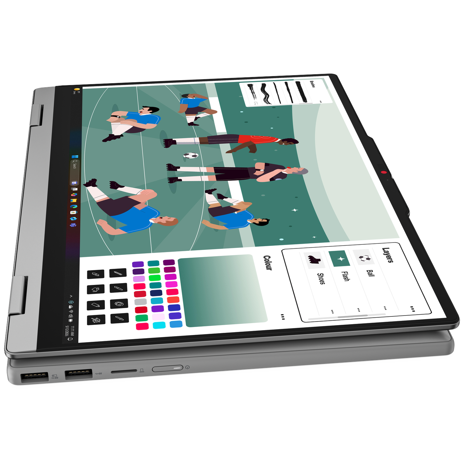 A laptop displays a digital drawing interface with soccer players and tools.