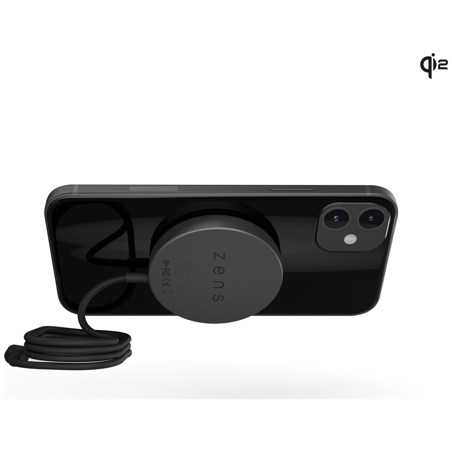 A black iPhone with a circular black wireless charger attached to its back, connected to a coiled black cable.