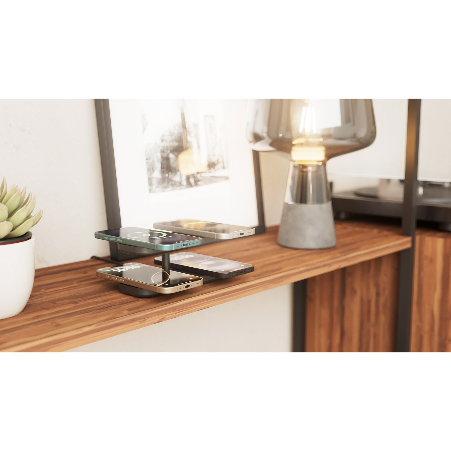 A multi-tiered phone charging stand on a wooden shelf, with four phones charging. A plant and lamp are nearby.