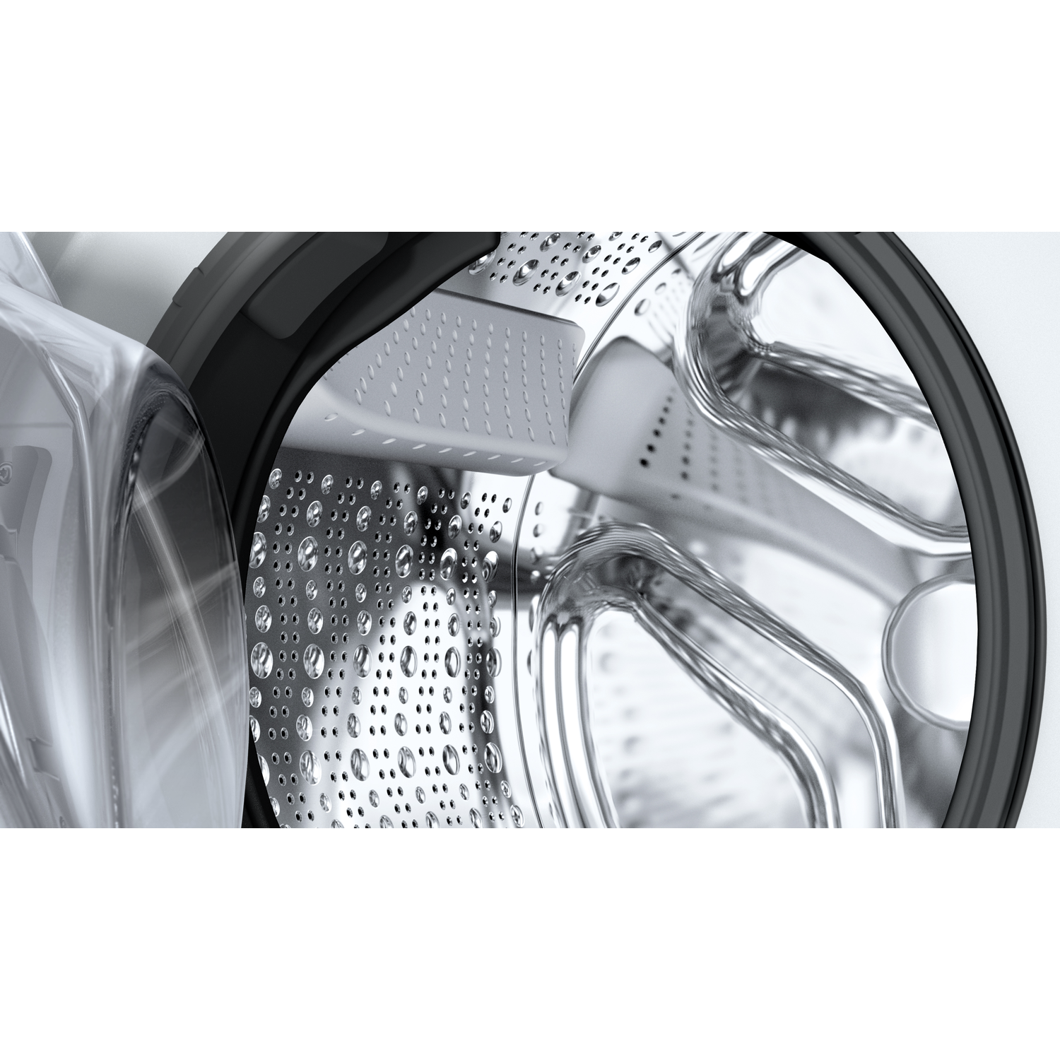 Close-up van een wasmachinetrommel met waterdruppels.