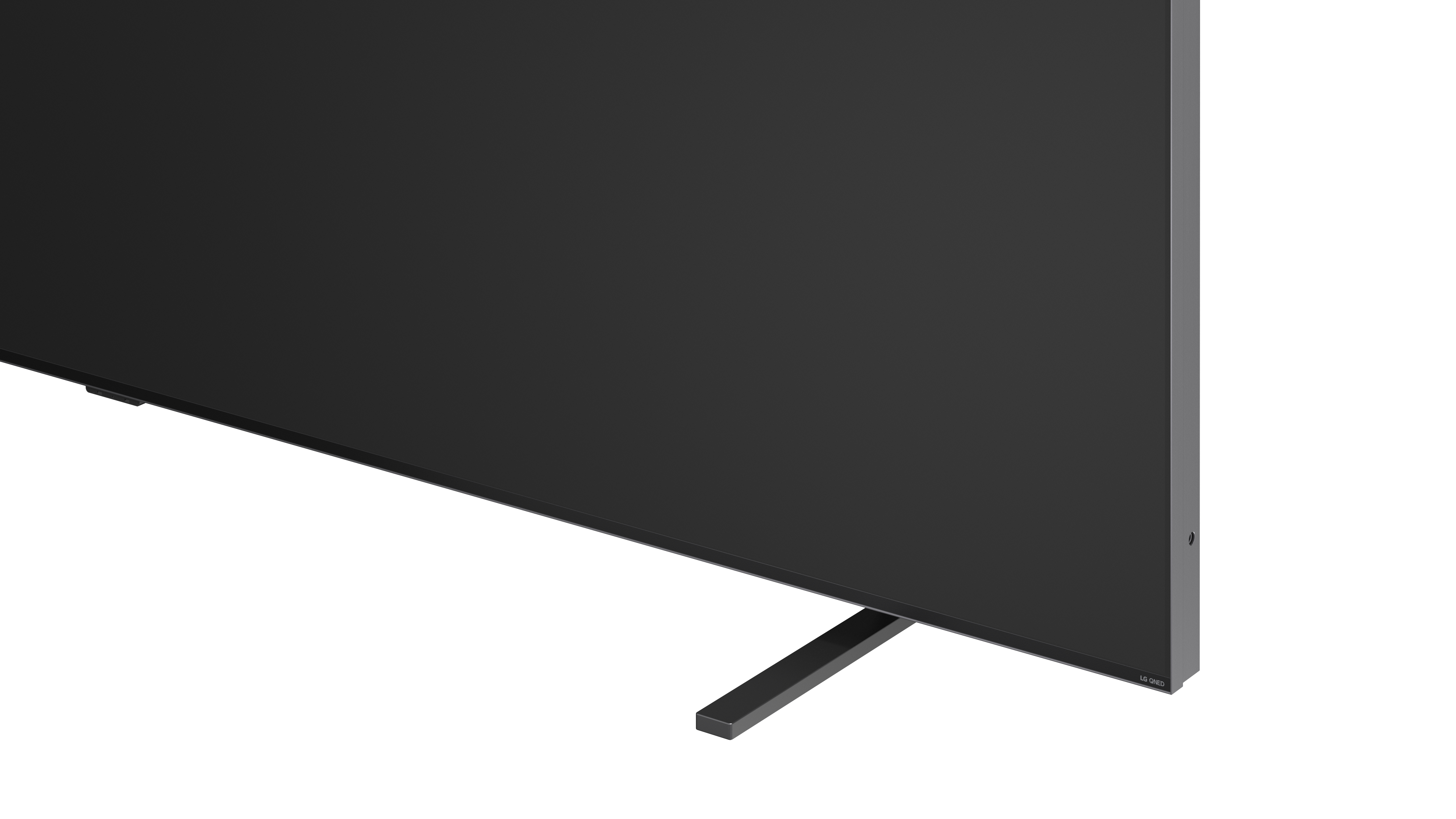 Ein schwarzer Fernseher mit einem schmalen Standfuß, nahaufnahme des unteren rechten Ecks.
