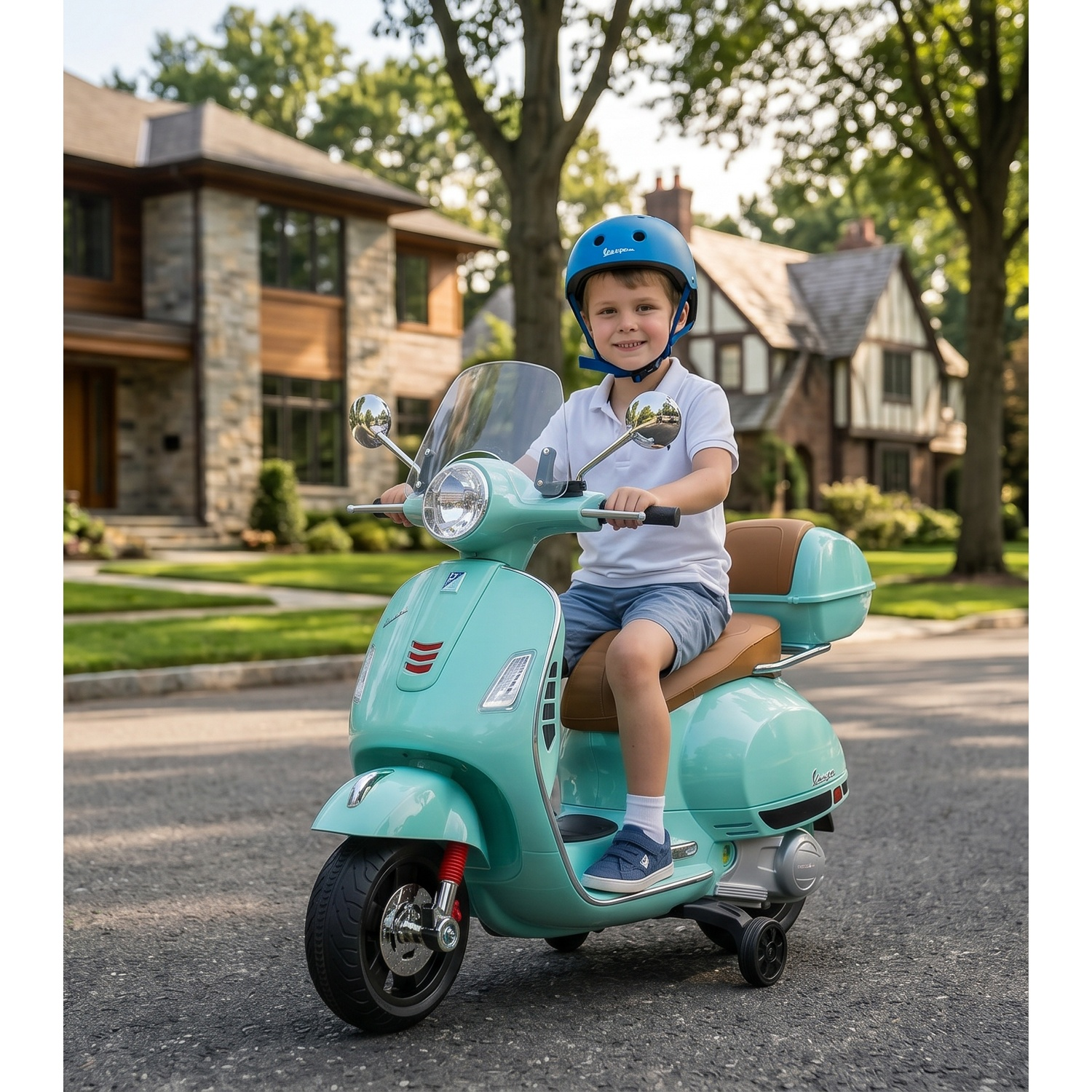 A boy in a blue helmet rides a mint green scooter in front of a house.