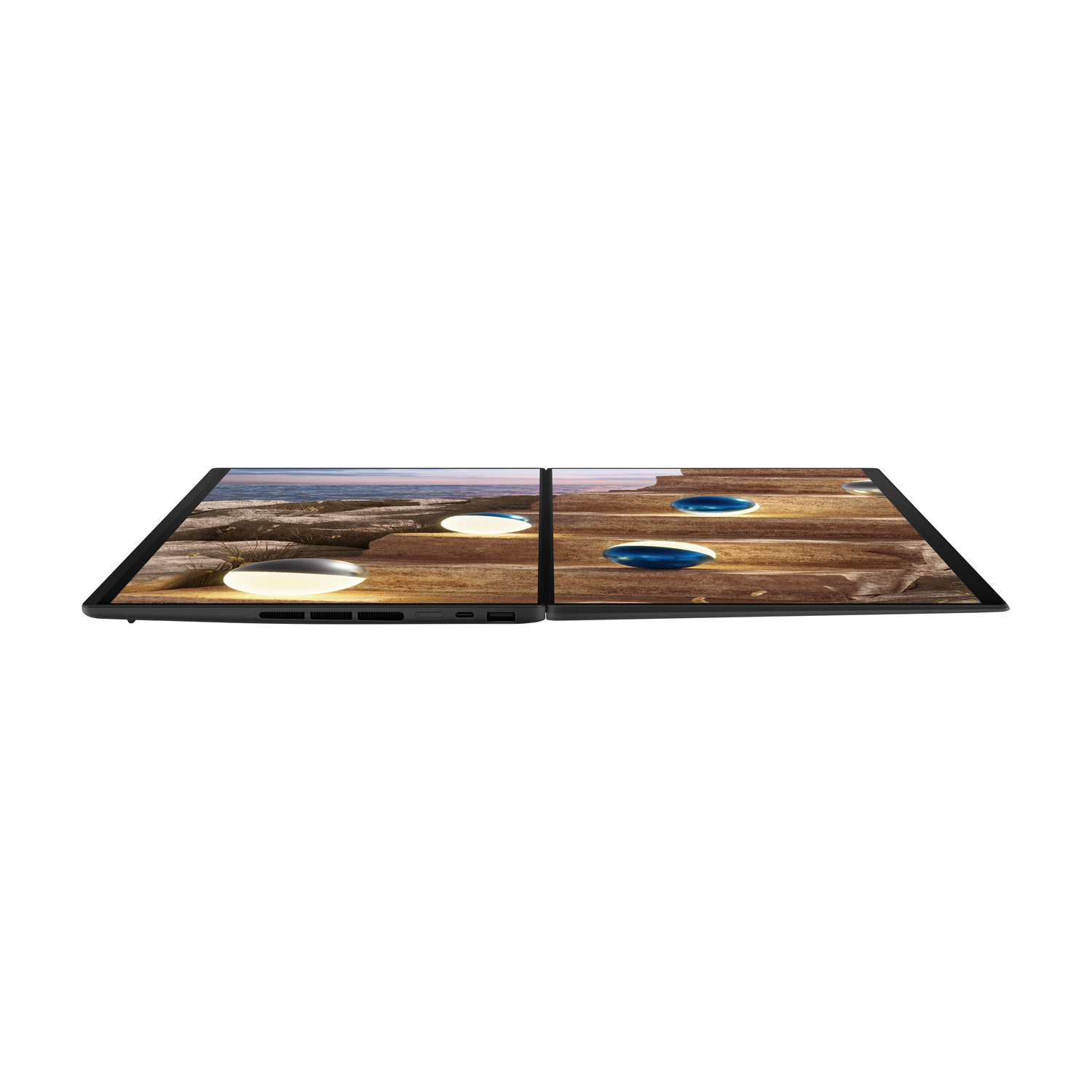 Un laptop aperto con due schermi che mostrano un paesaggio con luci.