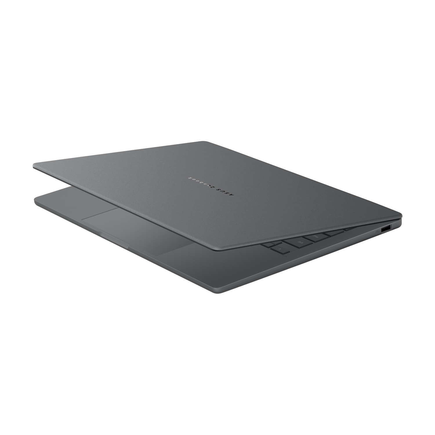 Un laptop grigio chiuso che mostra la tastiera e una porta USB sul lato.