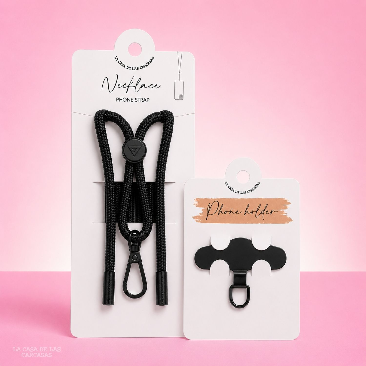 Due accessori per telefono: cinturino da collo nero e supporto nero su sfondo rosa.