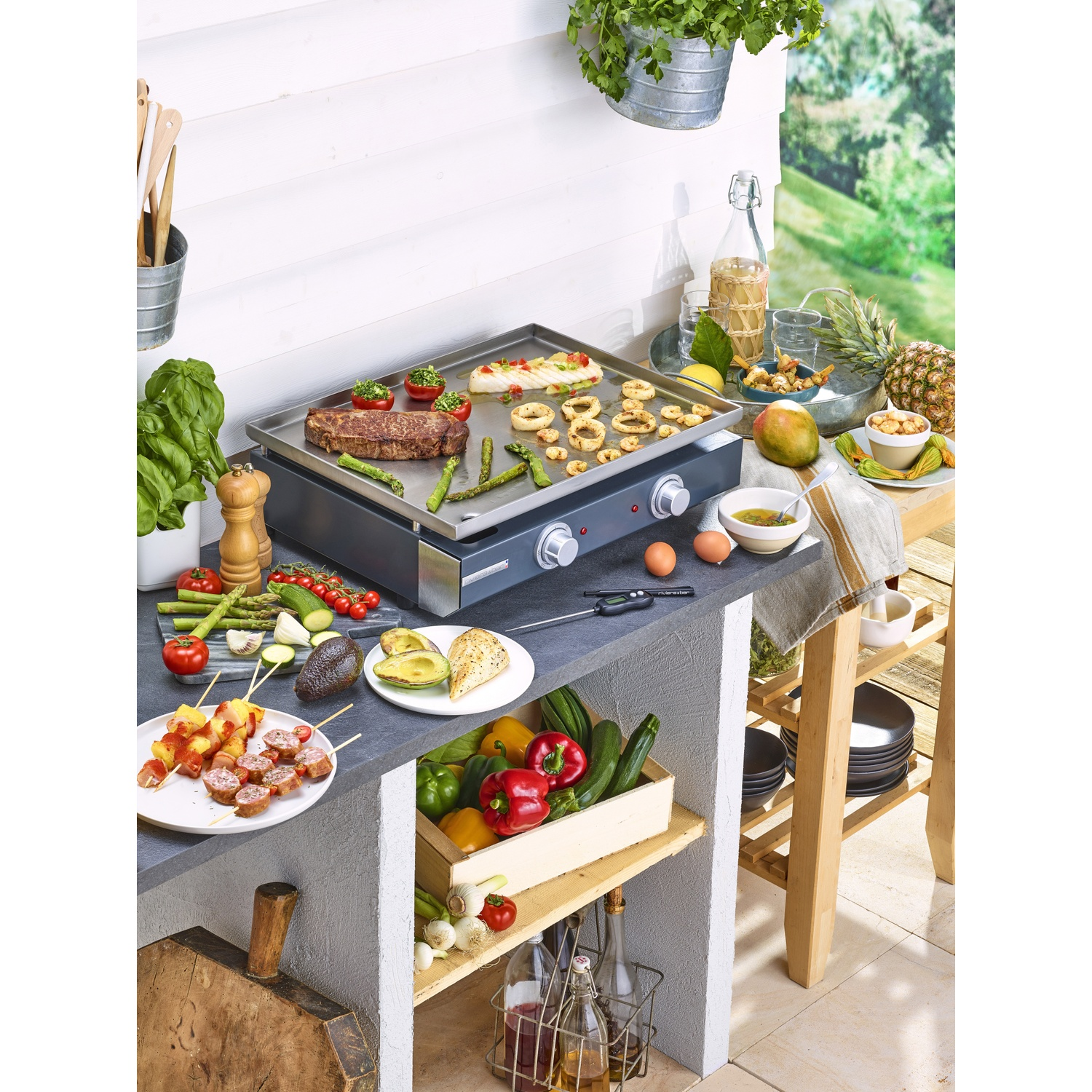 Grill met biefstuk, asperges en spiesjes. Vers fruit, groenten en drankjes eromheen.