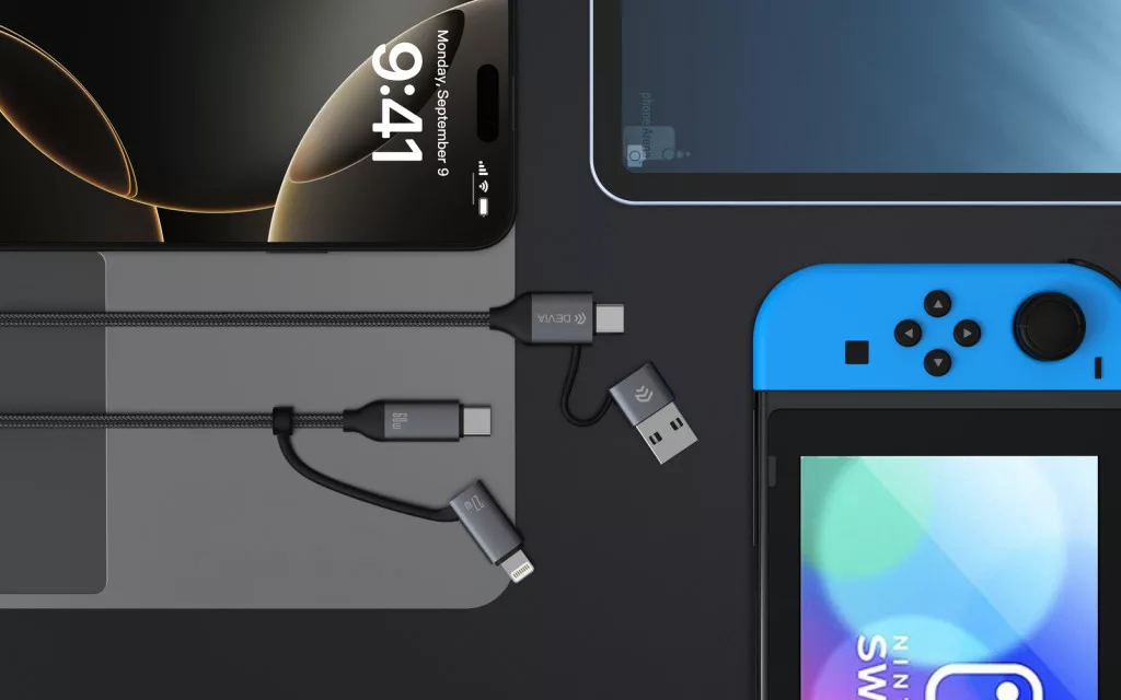 iPhone, Nintendo Switch és USB-C kábelek sötét felületen.