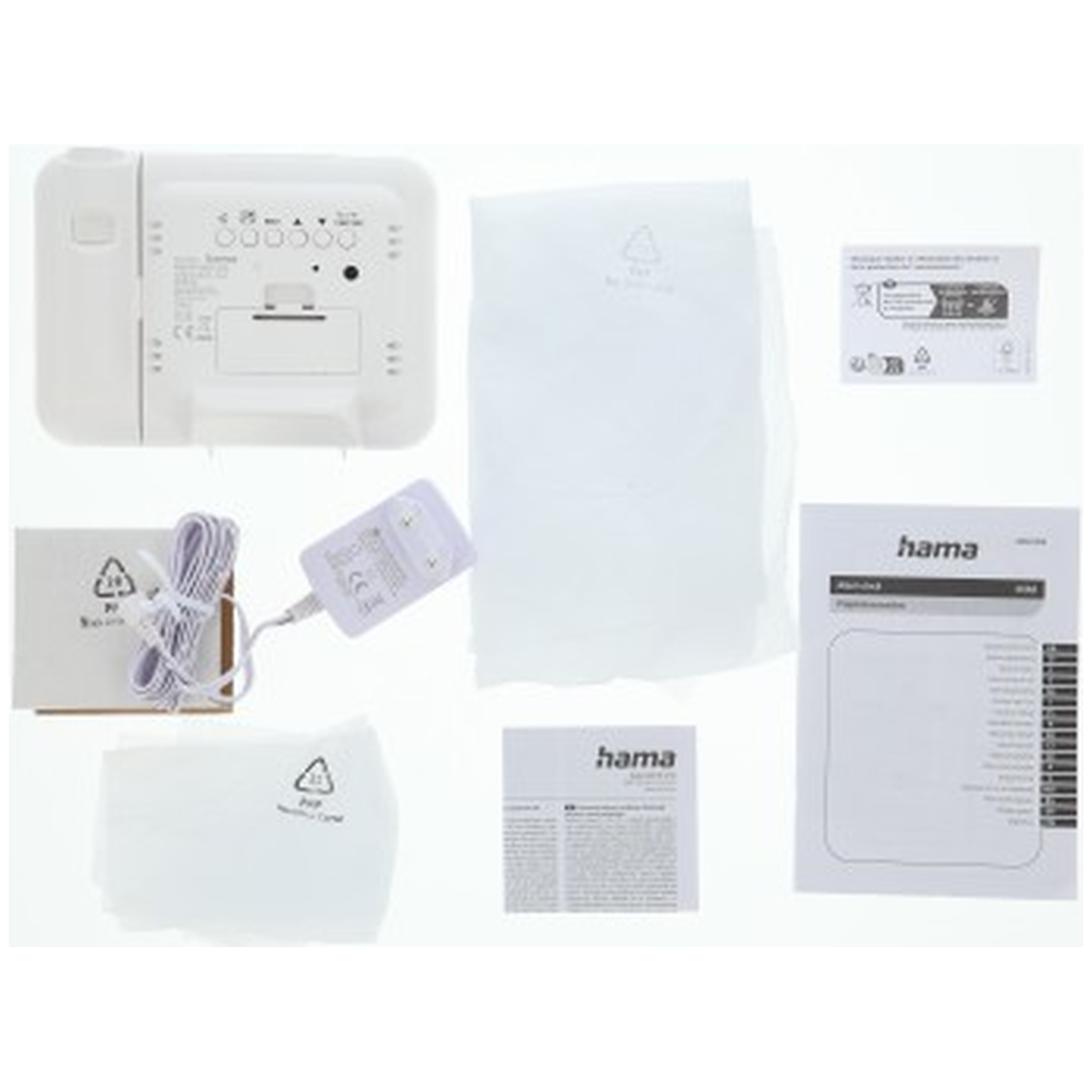 Een witte draadloze wekker set met accessoires, handleidingen en verpakkingsmateriaal.