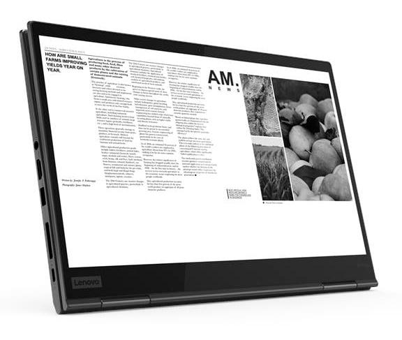 Ein Laptop zeigt eine Zeitungsseite mit Text und Bildern von Obst und Feldern.