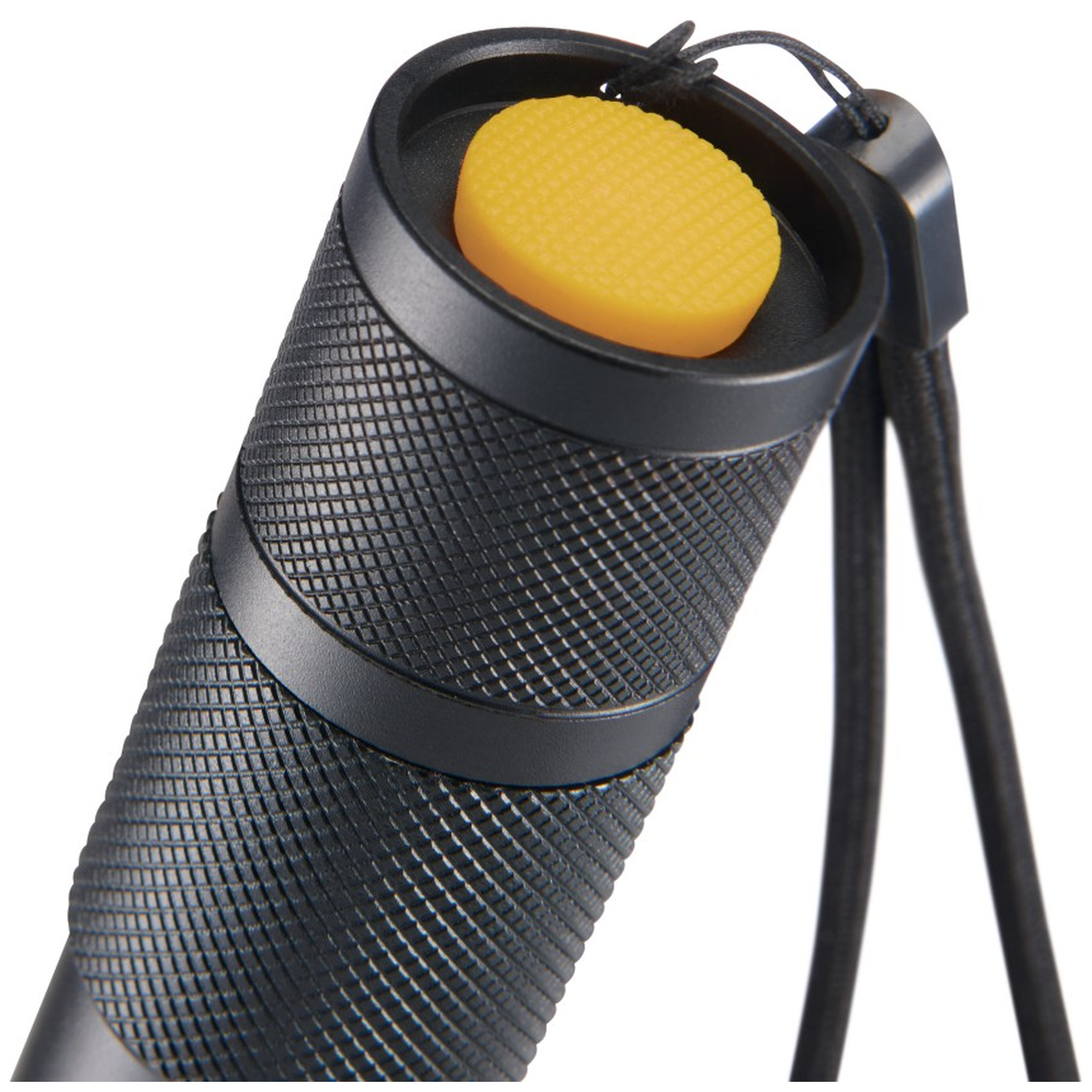 Black object with yellow button and lanyard, close-up view.
