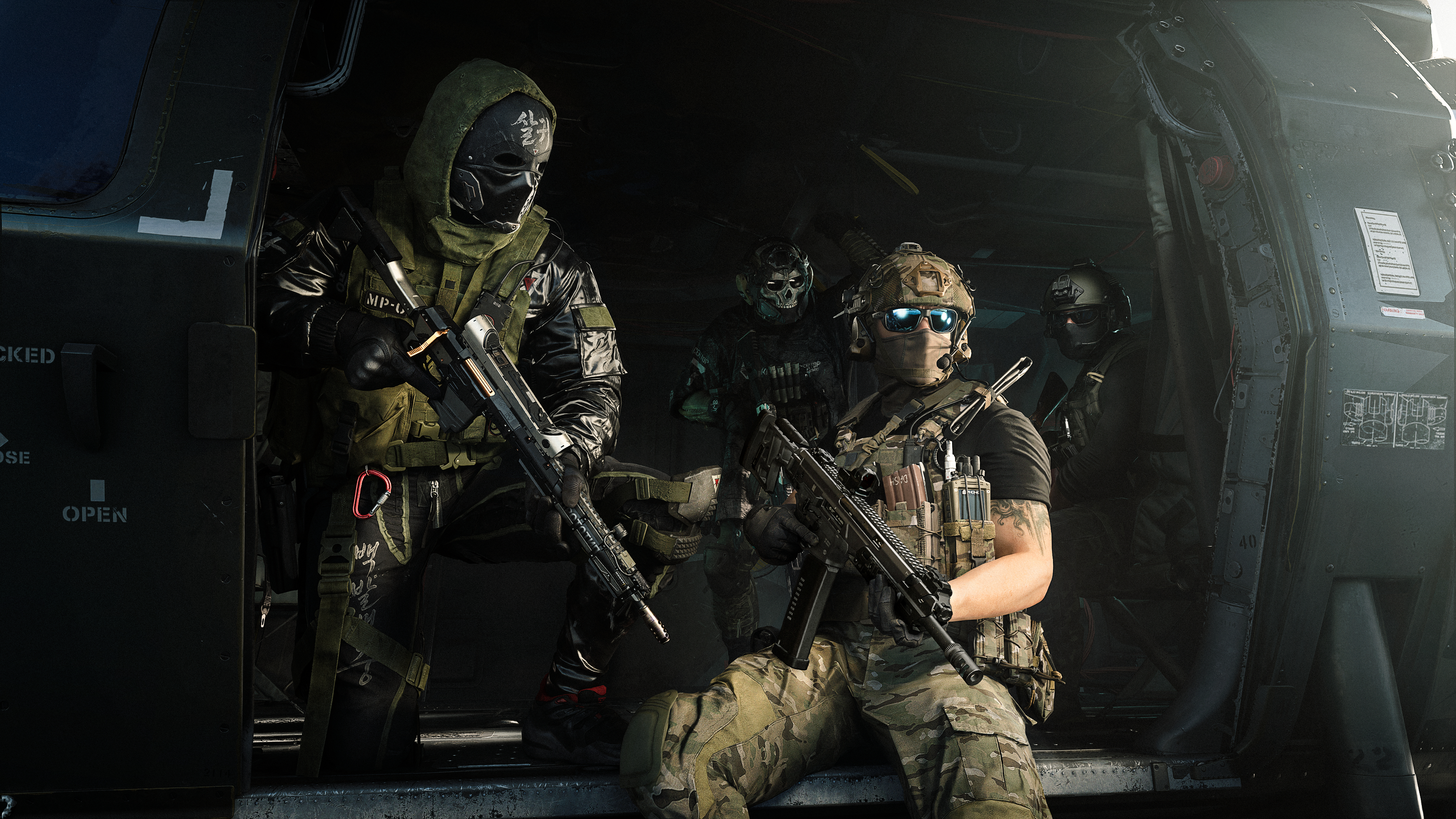 Soldaten in taktischer Ausrüstung mit Gewehren stehen in einem dunklen Helikopter.