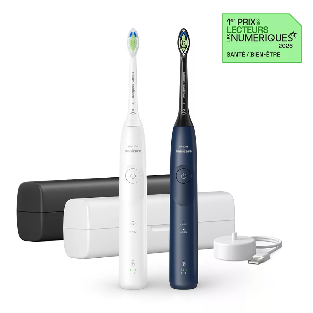 Dwa pędzle do zębów Philips Sonicare, biały i niebieski, z akcesoriami do ładowania i etui.