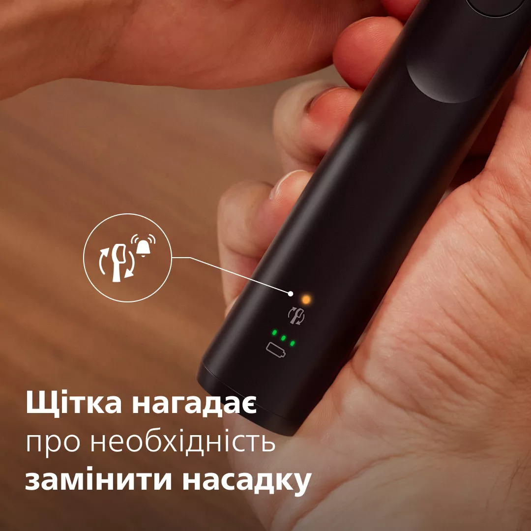 Czarny uchwyt szczoteczki elektrycznej ze wskaźnikami i ikoną.