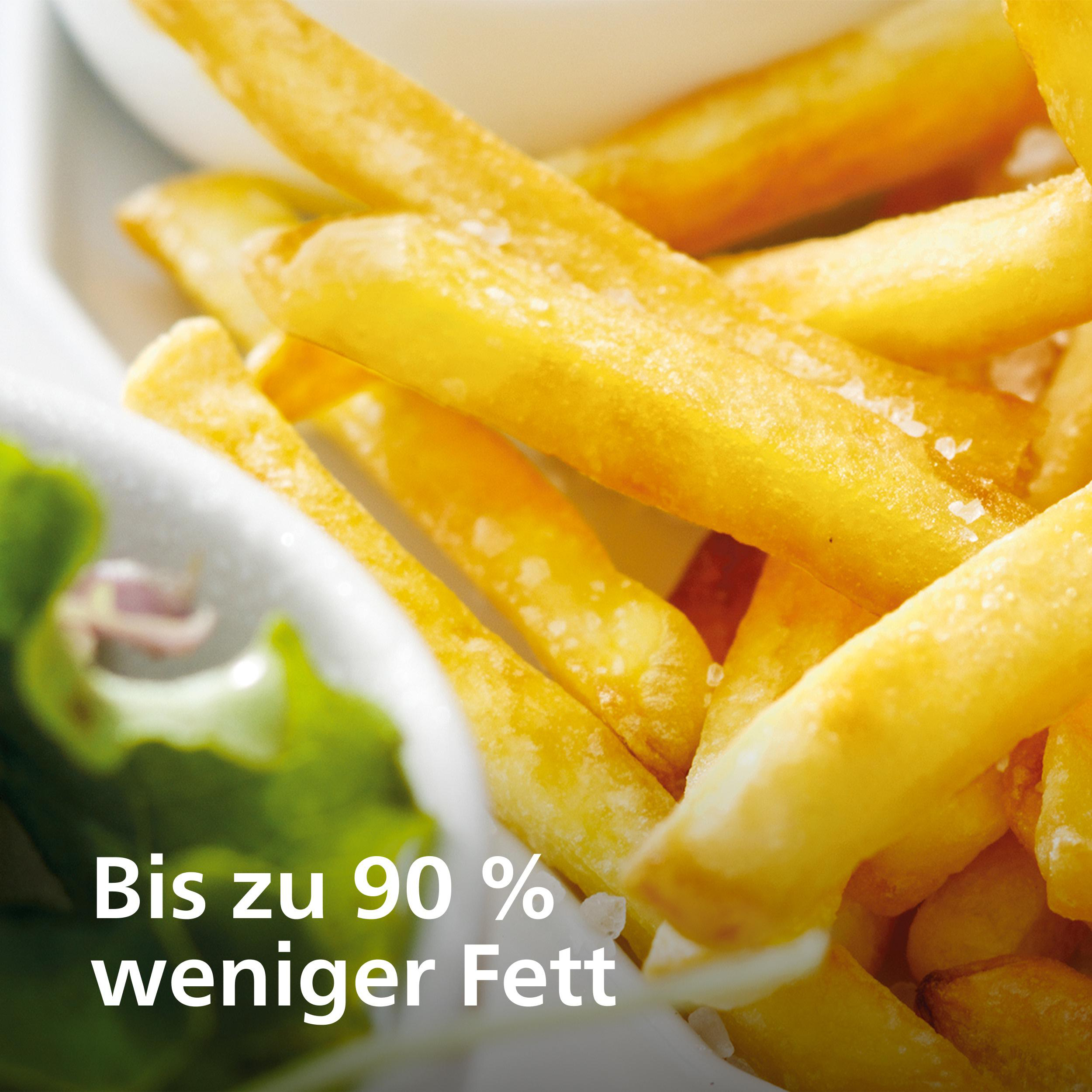 Pommes Frites mit Salz und Salatblatt, Text: Bis zu 90 % weniger Fett.