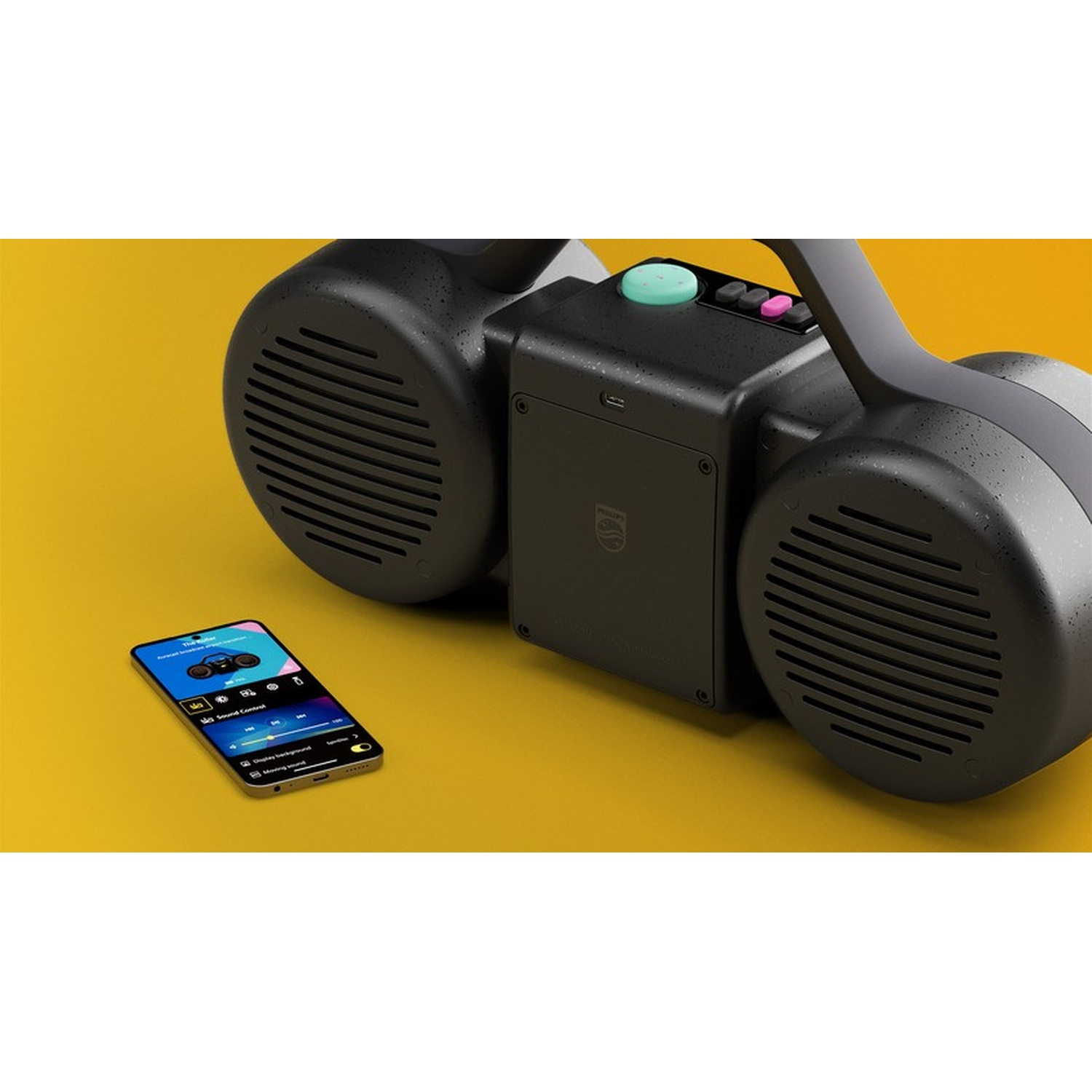 Uno speaker portatile nero con uno smartphone accanto su sfondo giallo.