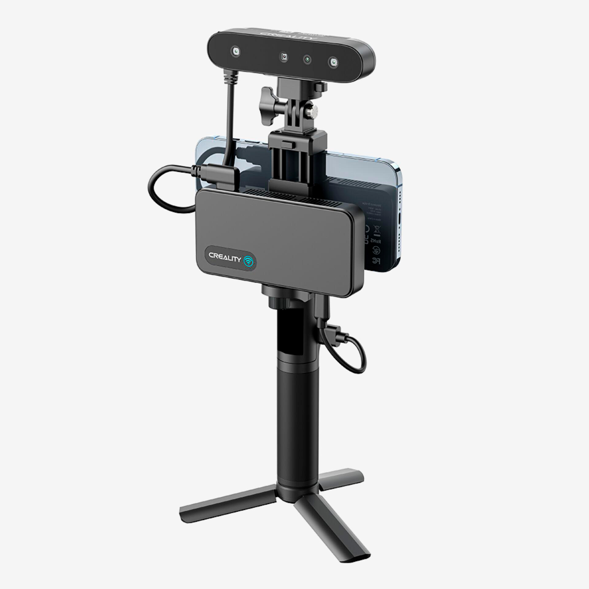 Ein schwarzer 3D-Scanner ist auf einem Stativ montiert, daneben ein Smartphone und ein Kasten.