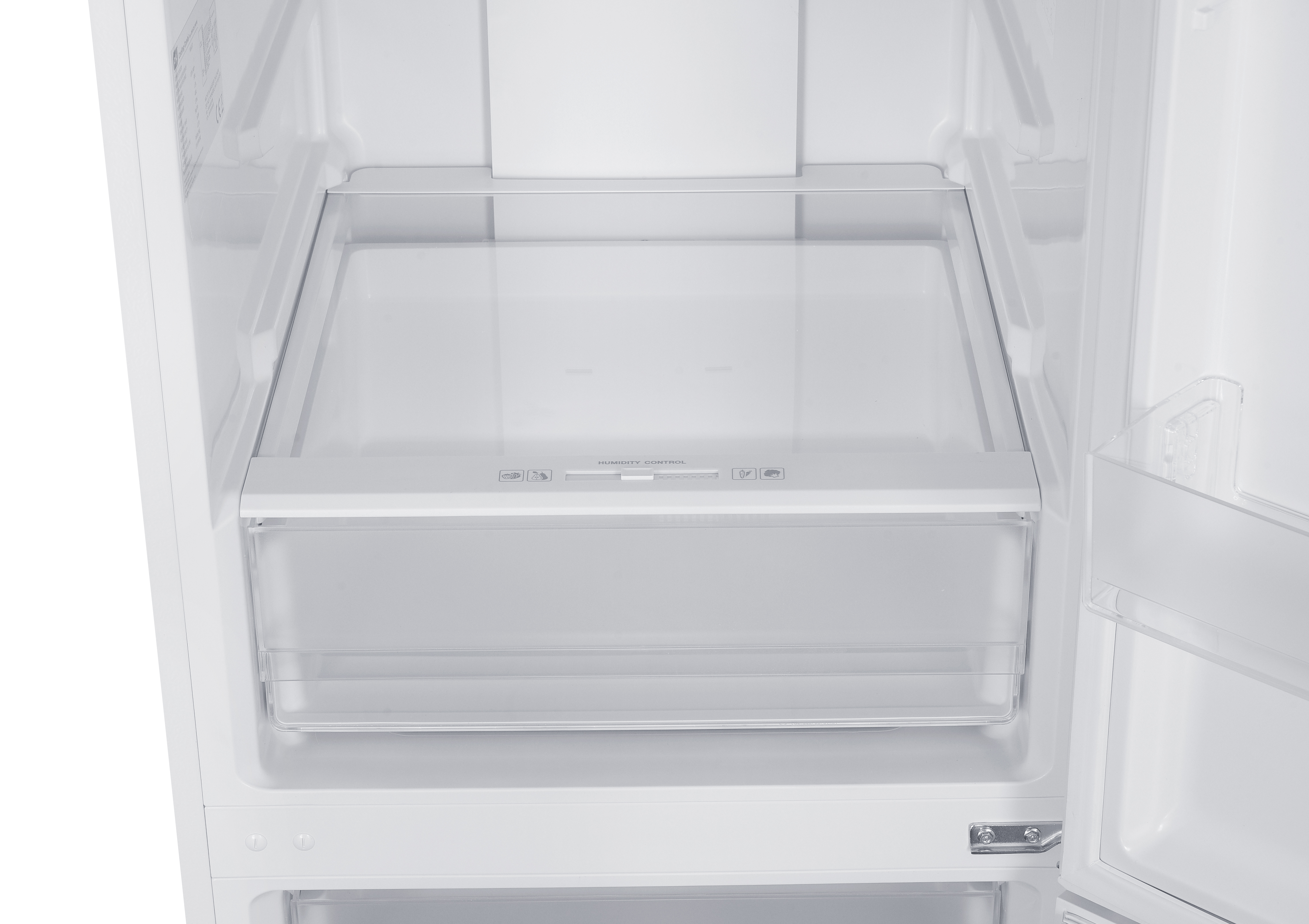 Interior vacío de un refrigerador con un cajón transparente y controles.
