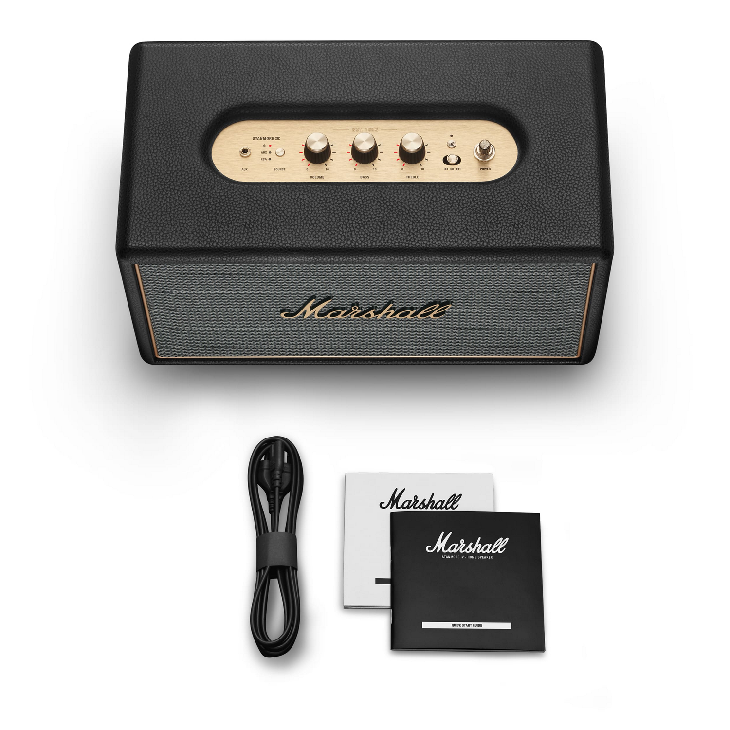 Altavoz Marshall negro con detalles dorados, cable de alimentación y manuales.
