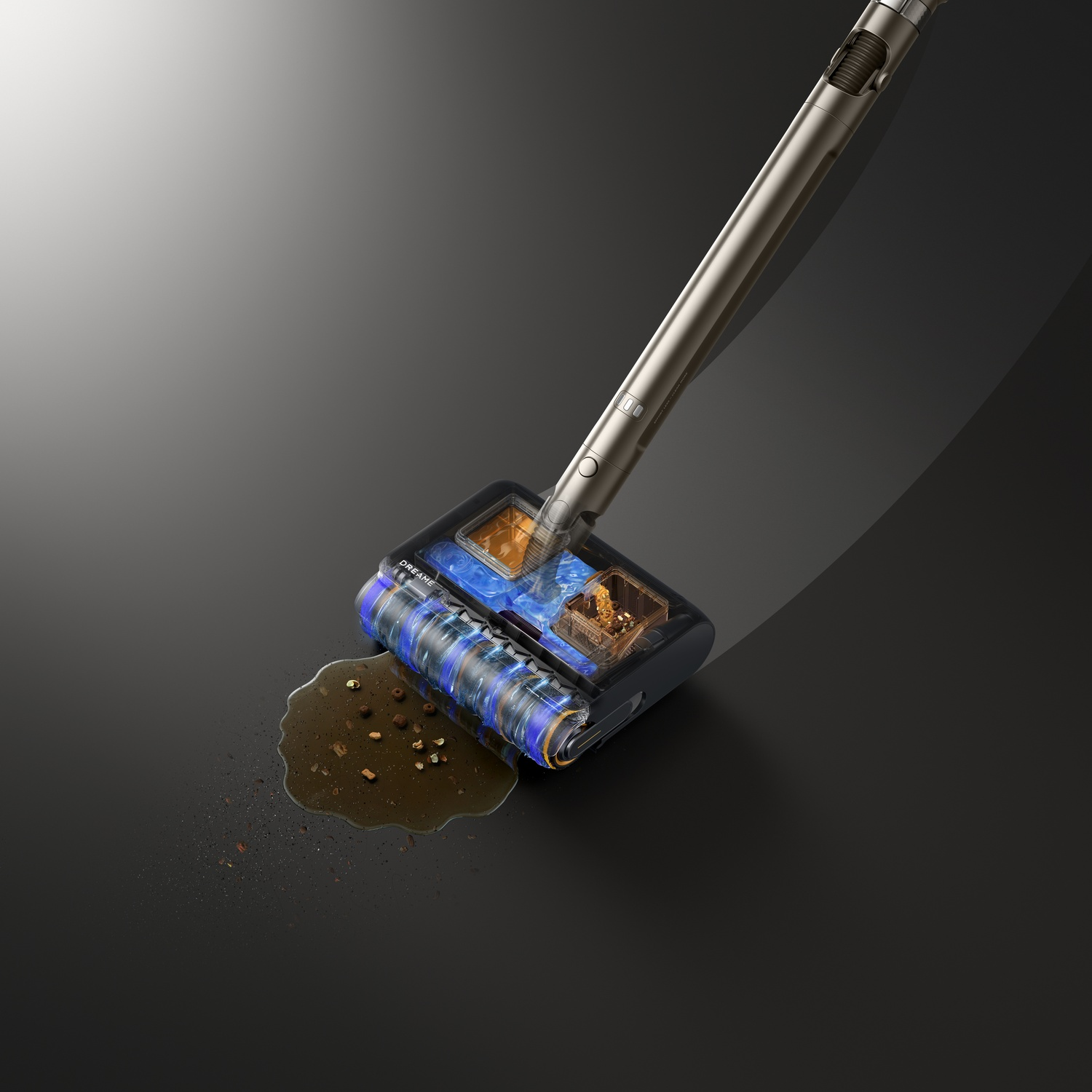 Een stofzuigerkop maakt een plas vloeistof en vuil schoon op een donkere vloer.