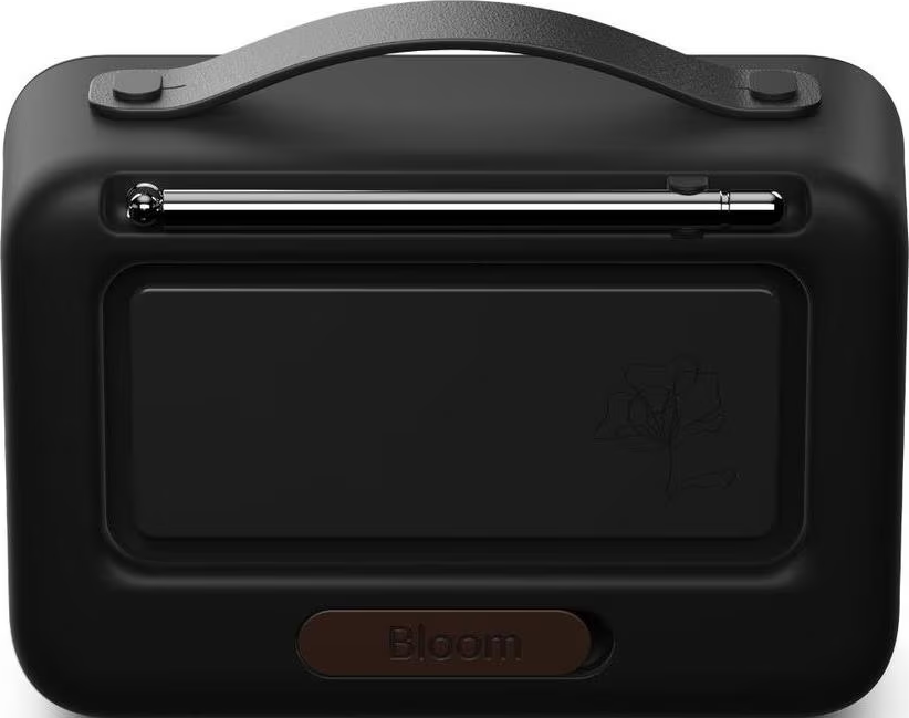Enceinte portable noire avec poignée argentée et motif floral stylisé.